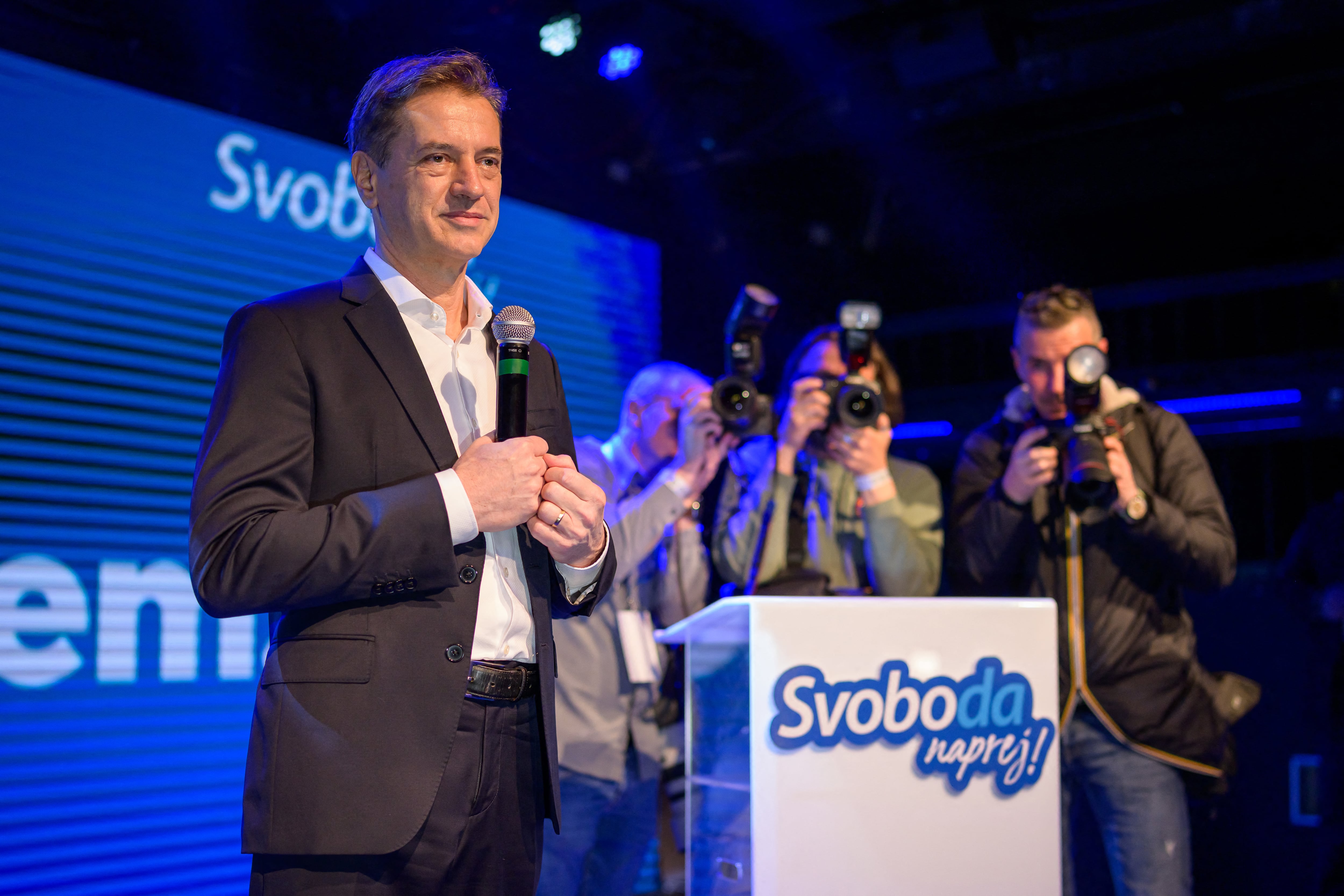 Slovenia�s Prime Minister Robert Golob (L) addresses the supporters of Gibanje Svoboda (The Freedom Movement) after the General Elections results are released in Ljubljana, Slovenia, on March 22, 2026. Slovenia's incumbent liberal Prime Minister Robert Golob on March 22, 2026 claimed victory in parliamentary elections, even as official results showed a neck and neck finish with the conservatives. (Photo by Jure Makovec / AFP)