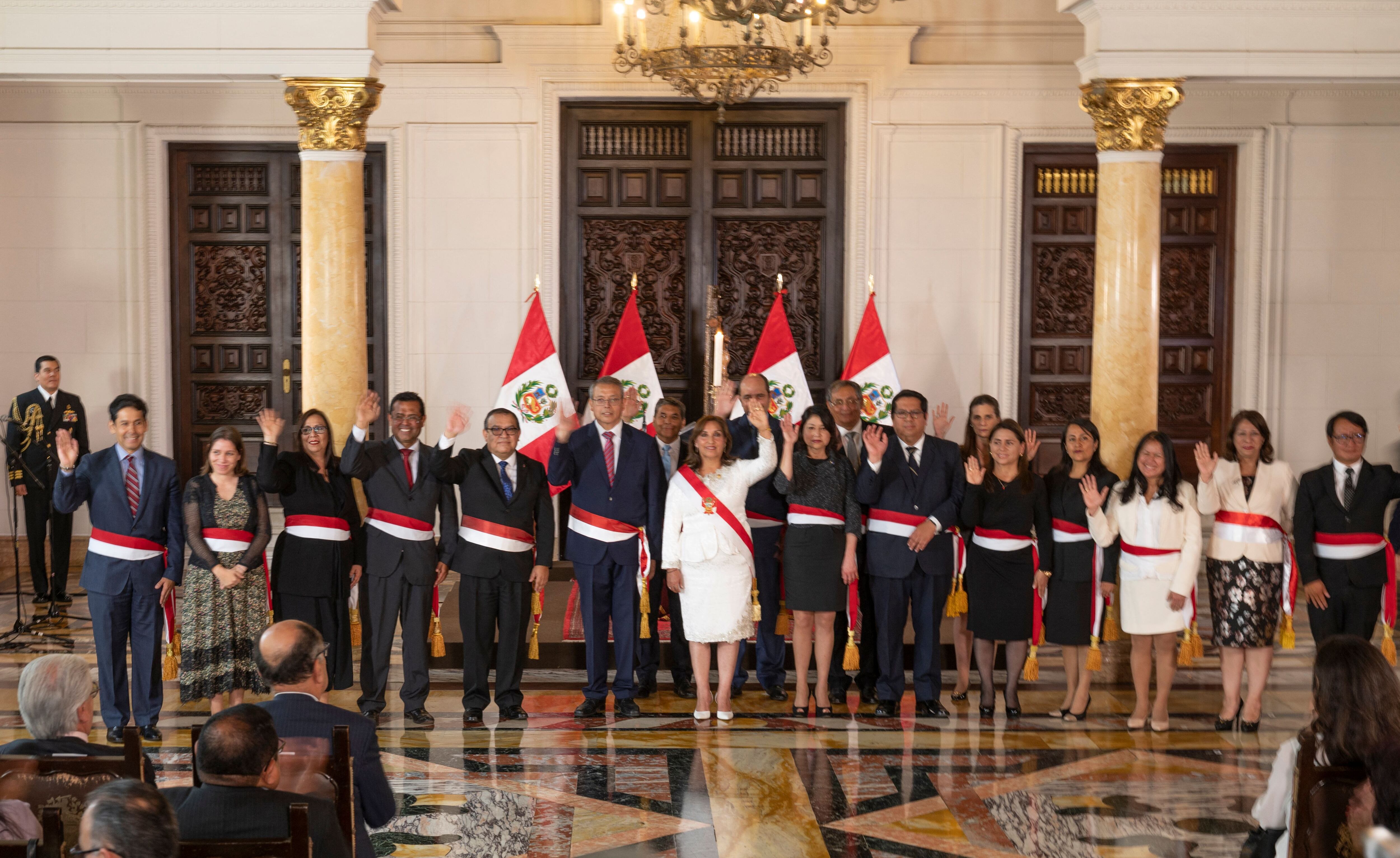 Peru's new President, Dina Boluarte (C), poses for a picture with her newly appointed cabinet ministers after the swearing-in ceremony at the Palace of Government in Lima on December 10, 2022. - The head of Peru's legislature called on December 10, 2022, on the country's new leader Dina Boluarte to appoint a new cabinet urgently amid continuing street protests following the removal of Pedro Castillo as president. (Photo by Cris BOURONCLE / AFP) (Photo by CRIS BOURONCLE/AFP via Getty Images)