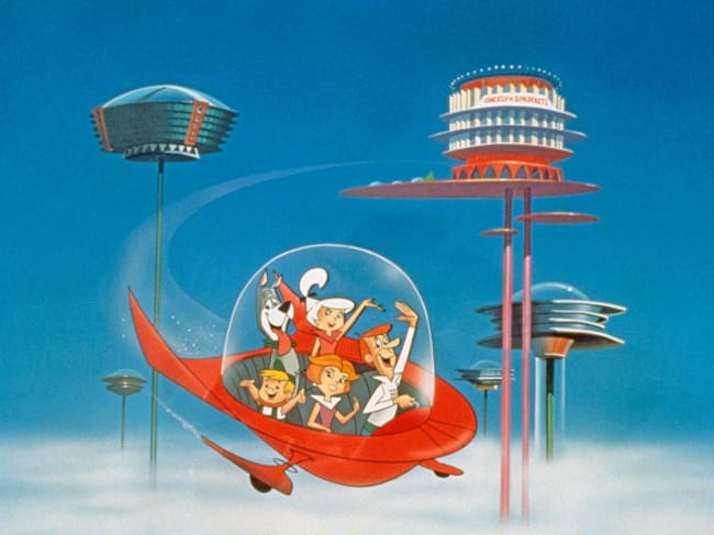 The Jetson family wave as they fly past buildings in space in their spaceship in a still from the animated television series, 'The Jetsons,' circa 1962. (Photo by Warner Bros./Courtesy of Getty Images)