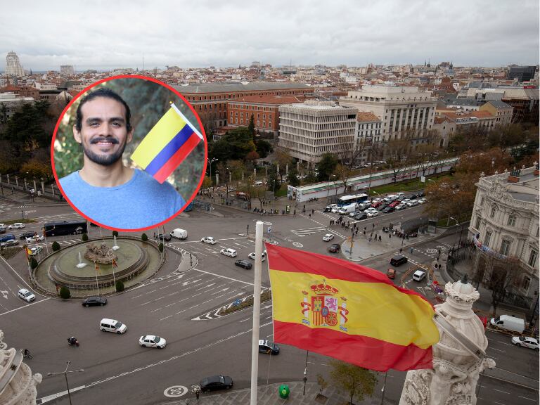Persona con una bandera de colombia y de fondo una panoramica de una ciudad española (Fotos vía Getty Images)