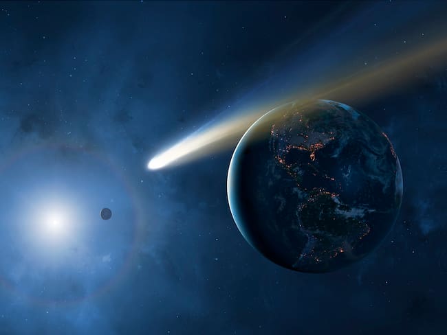 Ilustración de un cometa y la Tierra (Foto vía Getty Images)