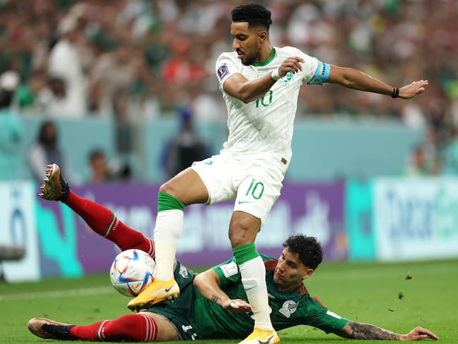LUSAIL CITY, QATAR - NOVEMBER 30: Salem Al-Dawsari of Saudi Arabia is tackled by Jorge Sanchez of Mexico during the FIFA World Cup Qatar 2022 Group C match between Saudi Arabia and Mexico at Lusail Stadium on November 30, 2022 in Lusail City, Qatar. (Photo by Lars Baron/Getty Images)