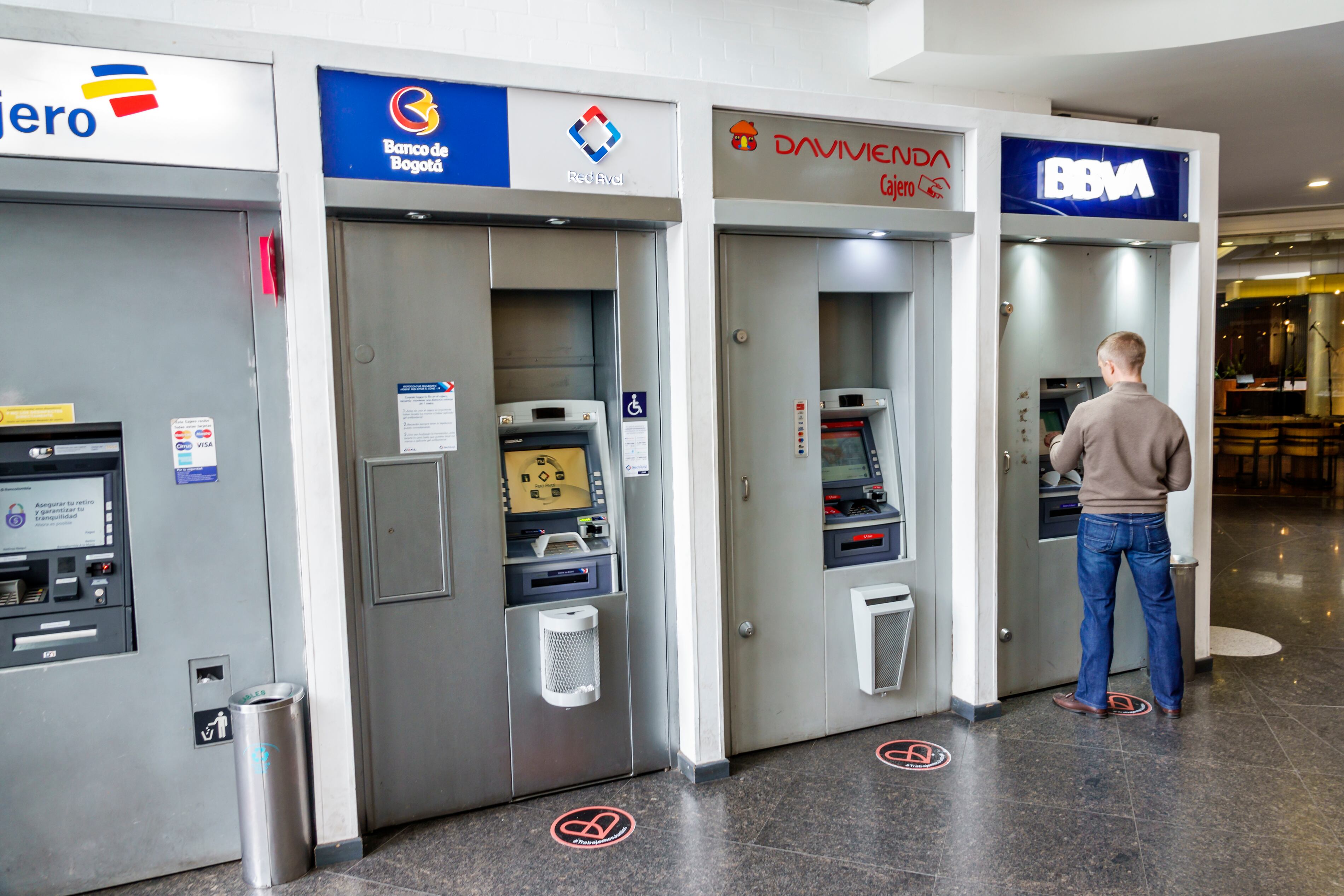 Bogota, Colombia, El Chico, BBVA Cajero Centro Commercial Portobelo ATM, Banco de Bogota Davivienda, man using ATM. (Photo by: Jeffrey Greenberg/Universal Images Group via Getty Images)