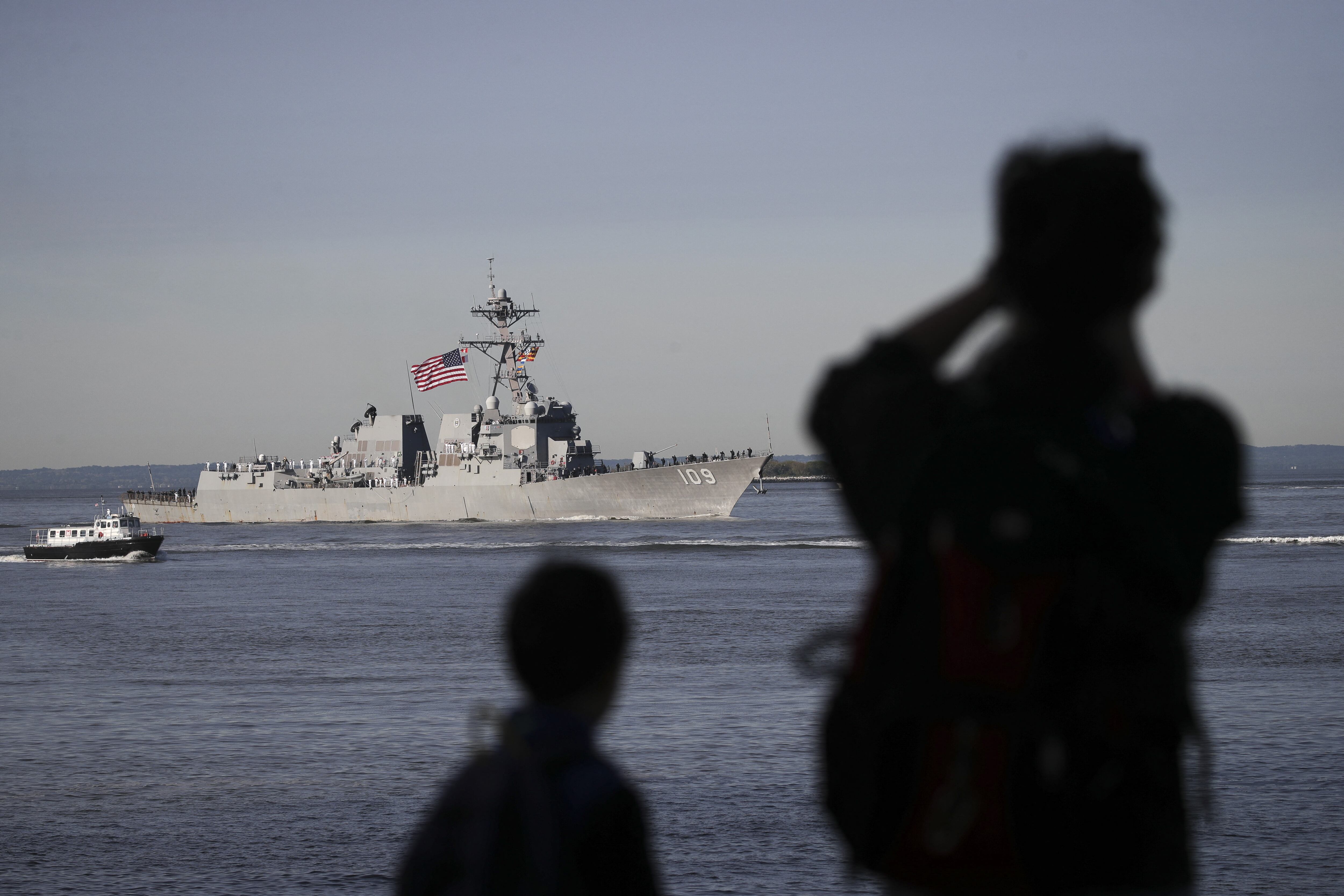 NEW YORK, NY - MAY 22: People watch along the shoreline as the USS Jason Dunham, a naval destroyer ship, sails into New York Harbor at the start of the Fleet Week Parade of Ships, May 22, 2019 in New York City. Now in its 31st year, Fleet Week runs through May 28 and celebrates the sea services.   Drew Angerer/Getty Images/AFP (Photo by Drew Angerer / GETTY IMAGES NORTH AMERICA / Getty Images via AFP)