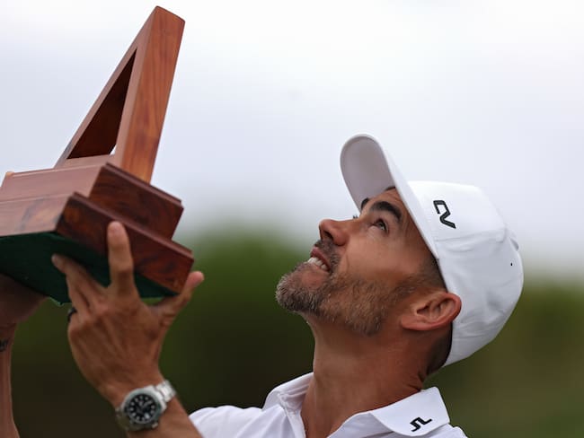 SOUTHAMPTON, BERMUDA - NOVEMBER 12: Camilo Villegas of Colombia celebrates looks skyward with the trophy after winning the Butterfield Bermuda Championship at Port Royal Golf Course on November 12, 2023 in Southampton, Bermuda. (Photo by Marianna Massey/Getty Images)