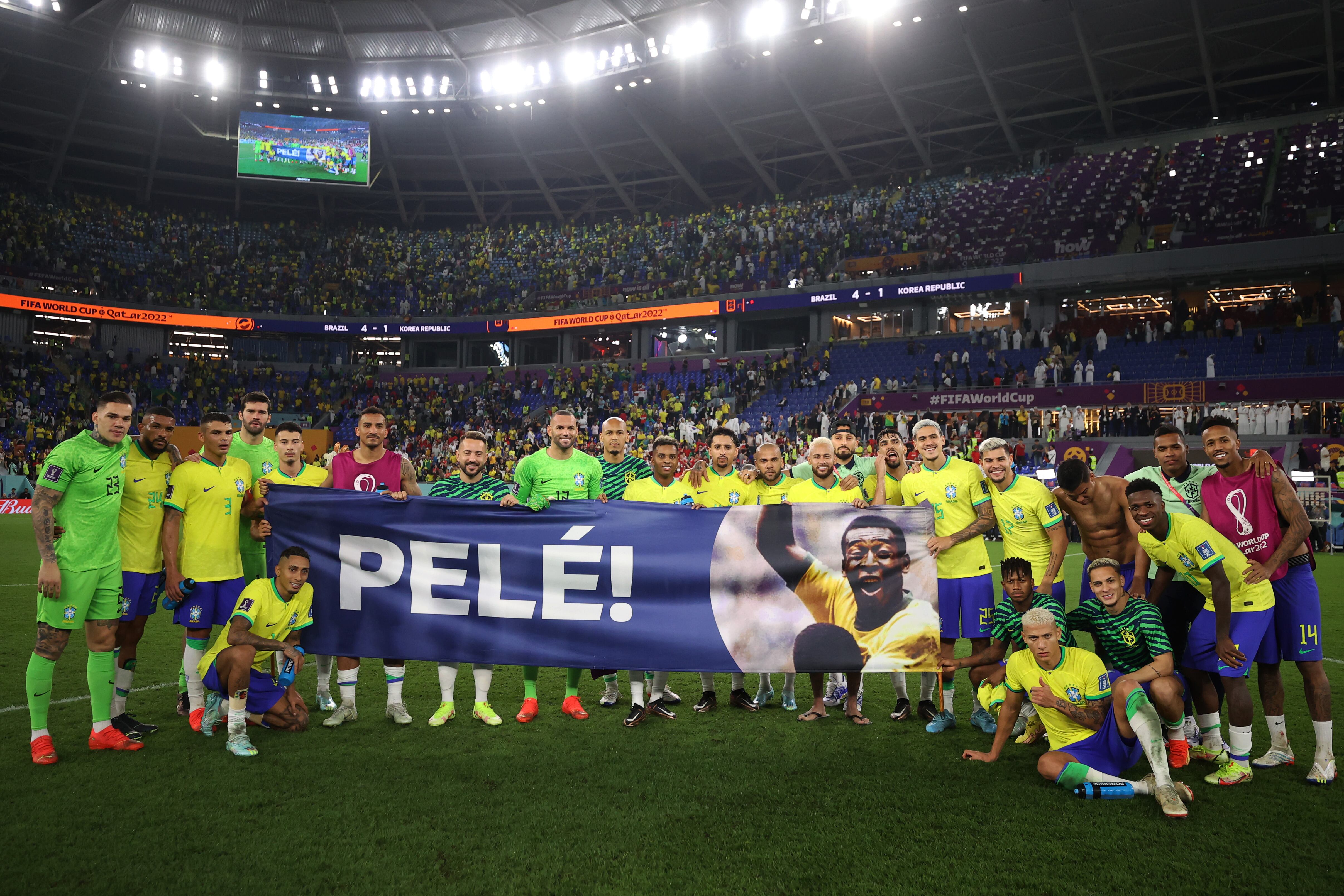 DOHA, QATAR - DECEMBER 05: Brazil players hold a banner showing support for former Brazil player Pele after the FIFA World Cup Qatar 2022 Round of 16 match between Brazil and South Korea at Stadium 974 on December 05, 2022 in Doha, Qatar. (Photo by Hector Vivas - FIFA/FIFA via Getty Images)