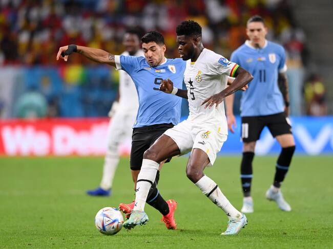 AL WAKRAH, QATAR - DECEMBER 02: Thomas Partey of Ghana battles for possession with Luis Suarez of Uruguay during the FIFA World Cup Qatar 2022 Group H match between Ghana and Uruguay at Al Janoub Stadium on December 02, 2022 in Al Wakrah, Qatar. (Photo by Stu Forster/Getty Images)