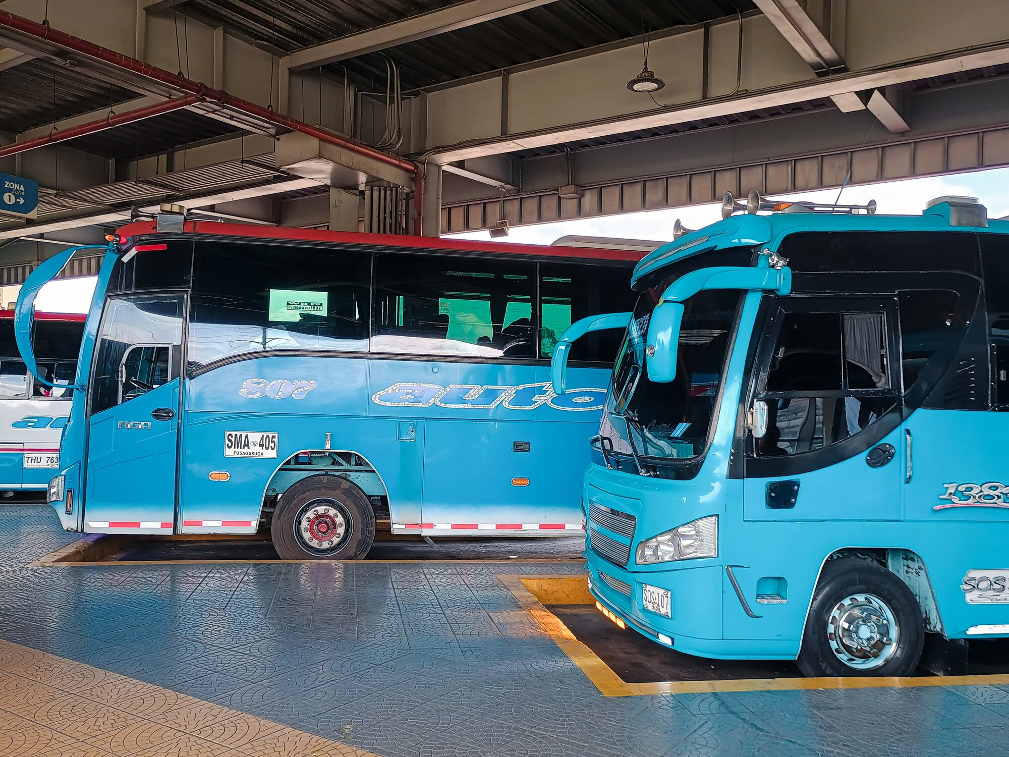 Bogotá, Cundinamarca, Colombia - October 19, 2024 - Blue Auto Fusa buses parked at the southern transport terminal