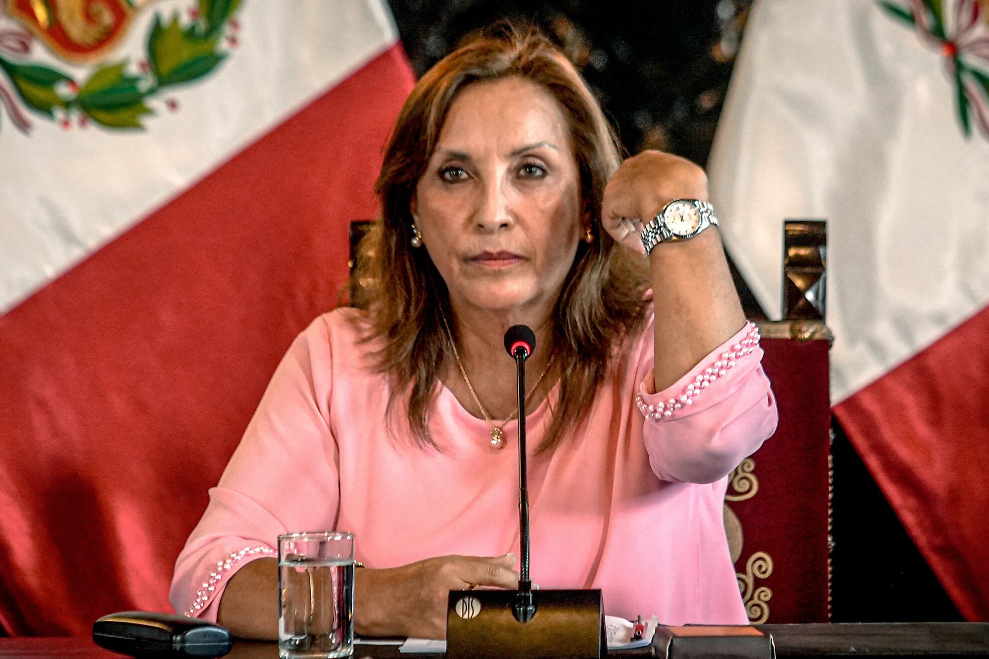 Peru's President Dina Boluarte shows a watch.