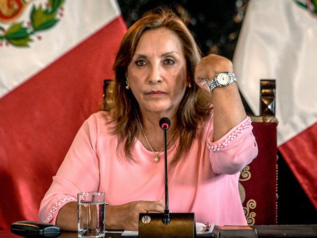 Peru&#039;s President Dina Boluarte shows a watch during a press conference at the government palace after her statement to the prosecutor&#039;s office, in Lima on April 05, 2024.