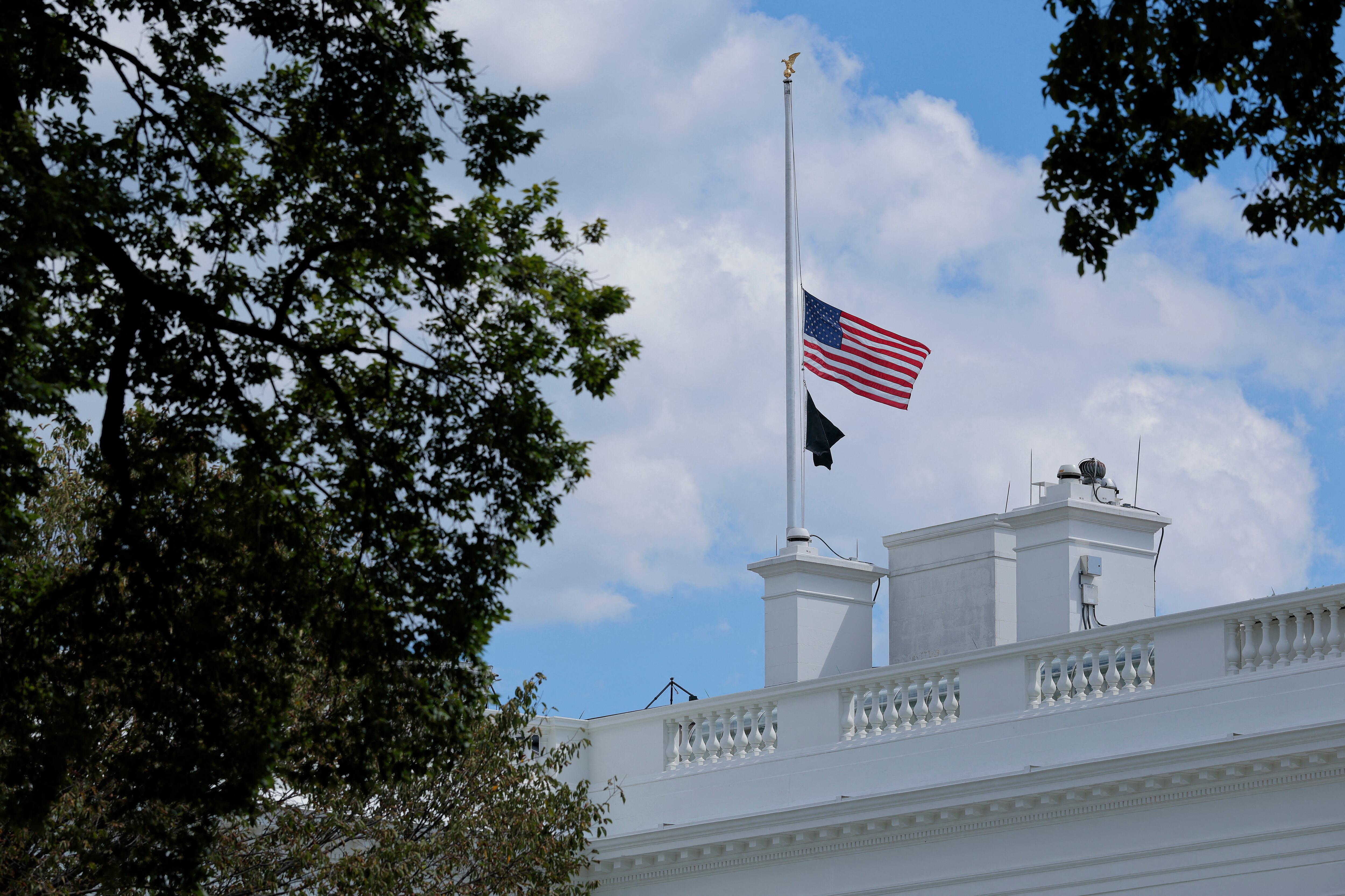 WASHINGTON, DC - AUGUST 27: The U.S. flag is lowered to half-staff above the White House on August 27, 2025 in Washington, DC. President Donald Trump ordered the flags lowered in memorial of the victims of today's mass shooting at a Minneapolis Catholic church and school.   Chip Somodevilla/Getty Images/AFP (Photo by CHIP SOMODEVILLA / GETTY IMAGES NORTH AMERICA / Getty Images via AFP)