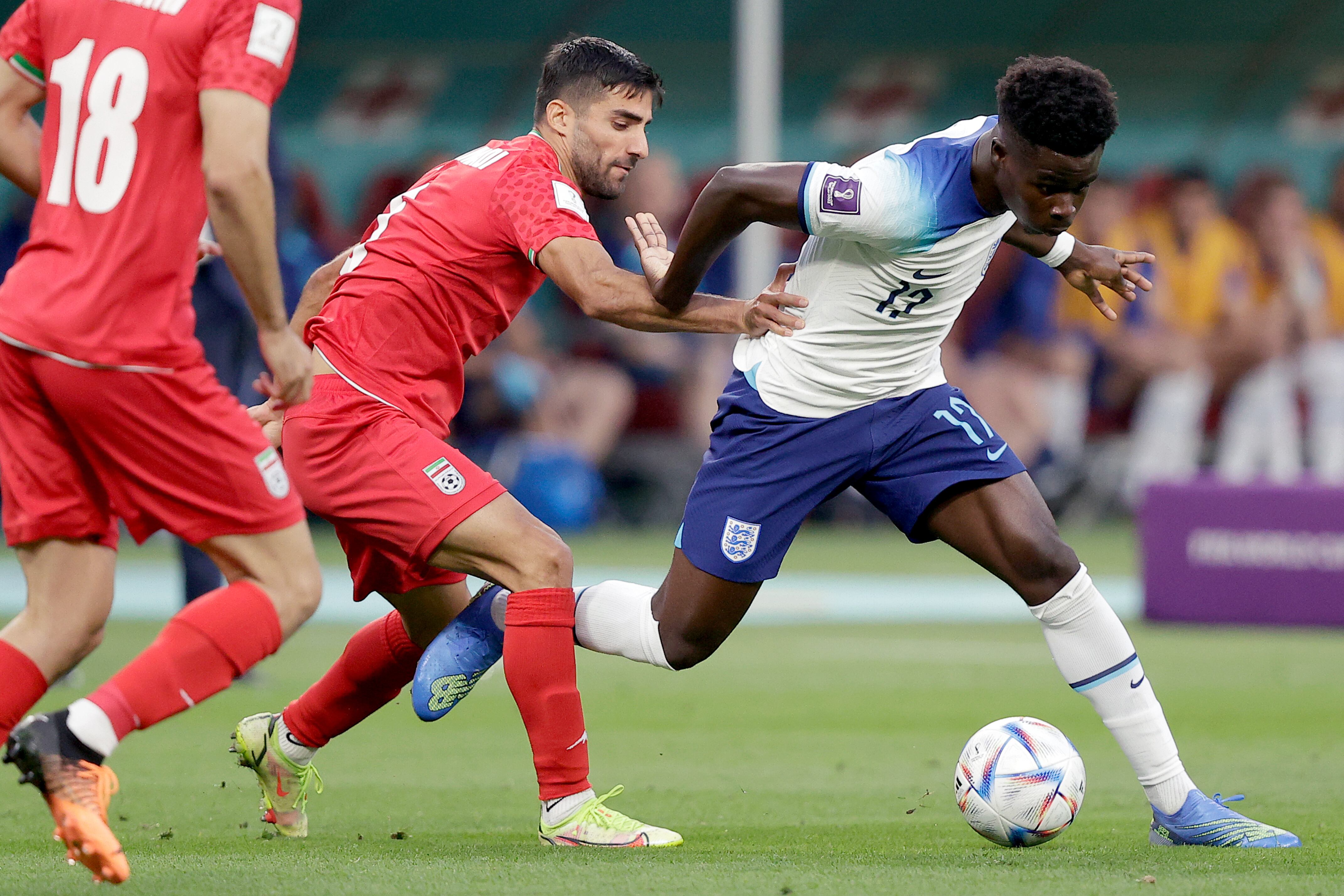 DOHA, QATAR - NOVEMBER 21:  (L-R) Milad Mohammadi of Iran, Bukayo Saka of England  during the  World Cup match between England  v Iran at the Khalifa International Stadium on November 21, 2022 in Doha Qatar (Photo by David S. Bustamante/Soccrates/Getty Images)