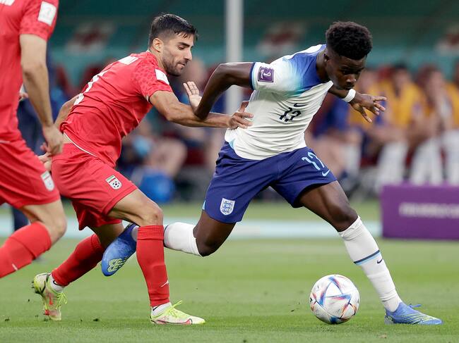DOHA, QATAR - NOVEMBER 21: (L-R) Milad Mohammadi of Iran, Bukayo Saka of England during the World Cup match between England v Iran at the Khalifa International Stadium on November 21, 2022 in Doha Qatar (Photo by David S. Bustamante/Soccrates/Getty Images)
