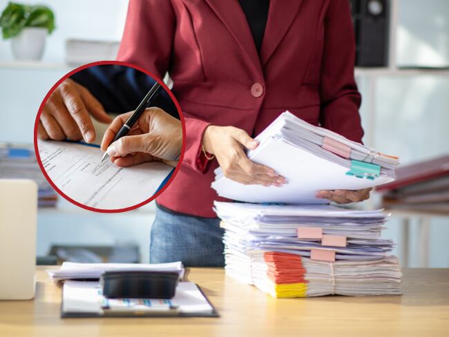 Persona con mucho trabajo // persona firmando un documento // Getty Images