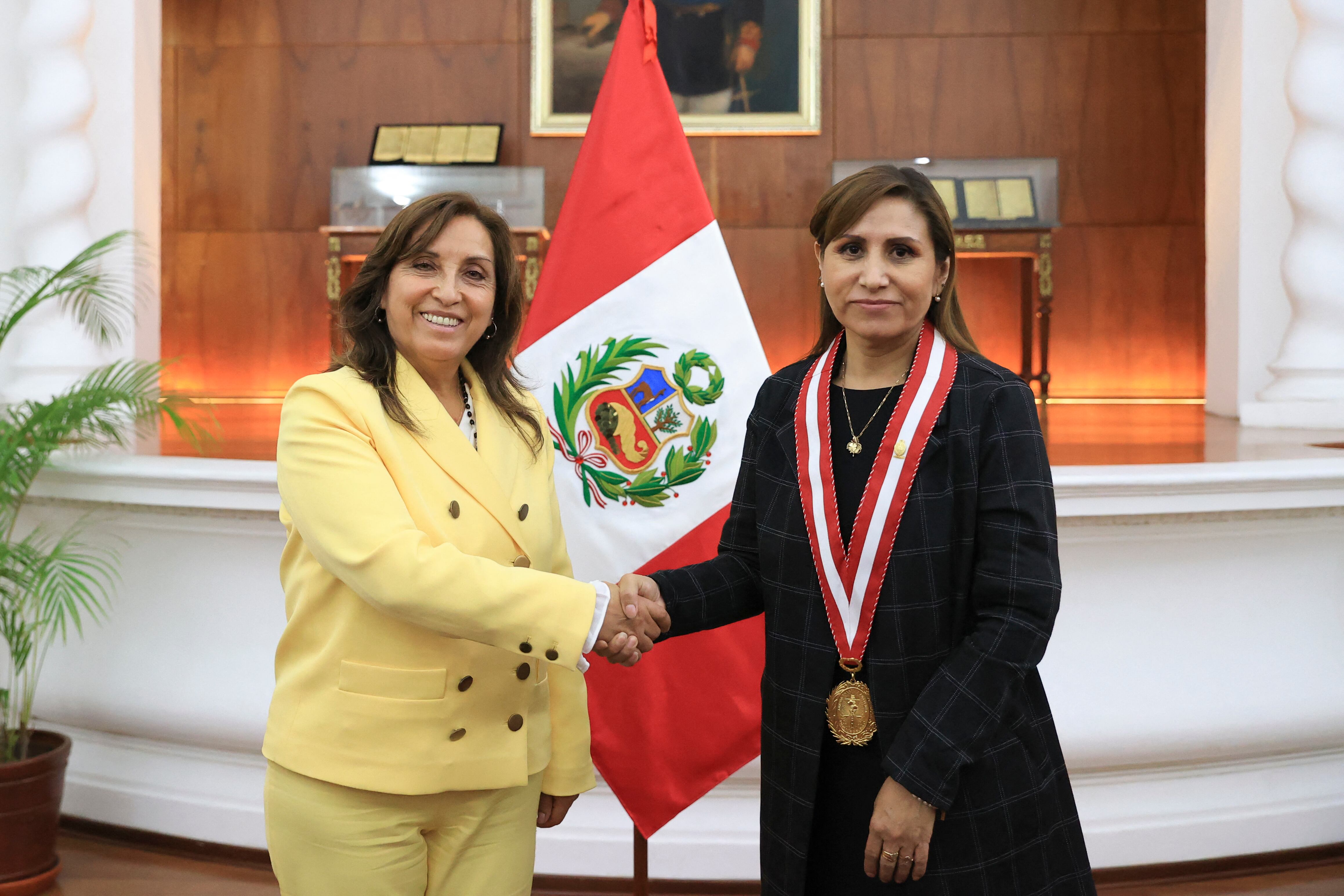 In this handout picture released by the Peruvian Presidency Peru's new President Dina Boluarte (L) shakes hands with attorney general Patricia Benavides (R) during a meeting after Boluarte's swearing in ceremony in Lima, on December 7, 2022.