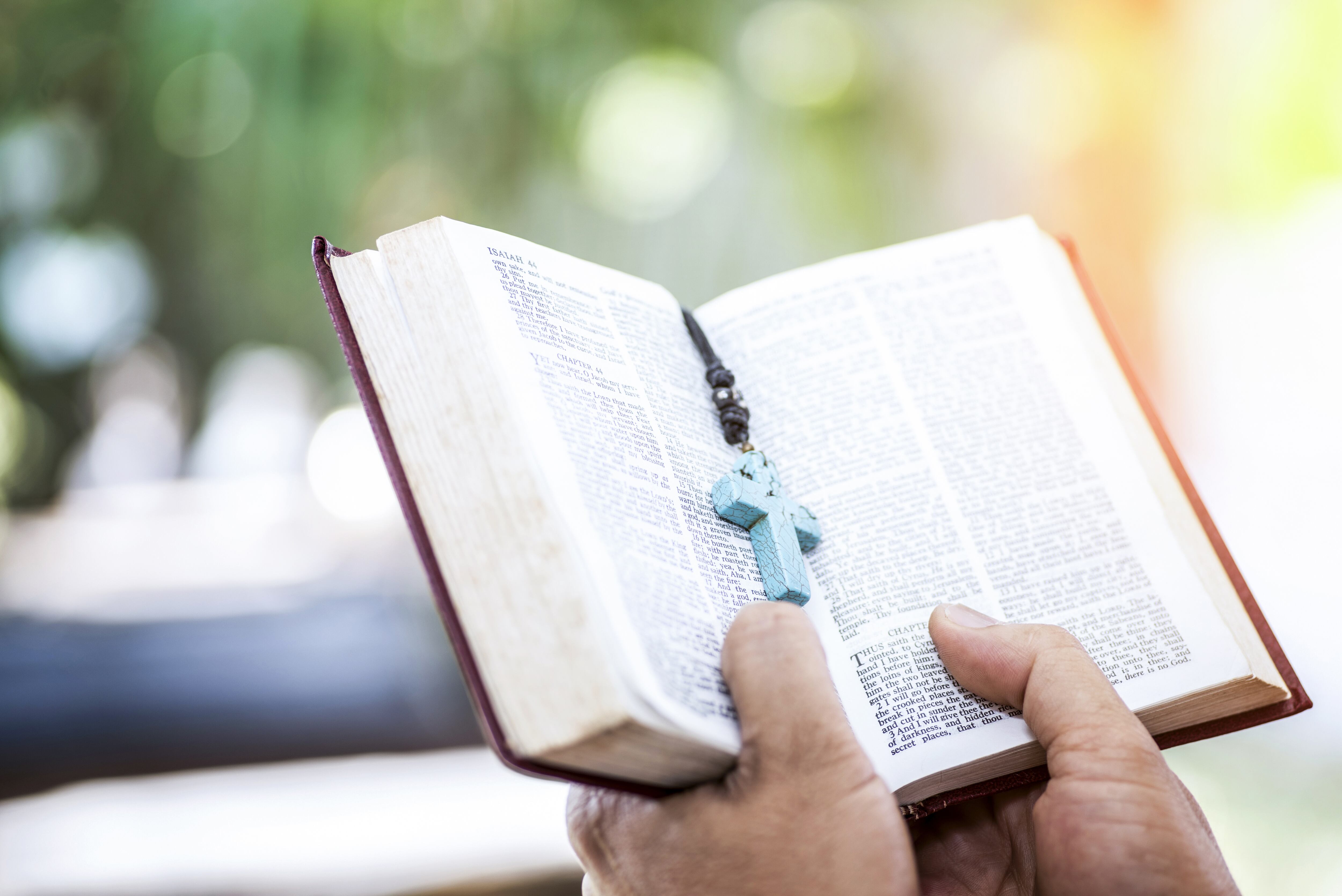 Close up of young man hands hold and reading holy bible.Christian faith concept stock photo.