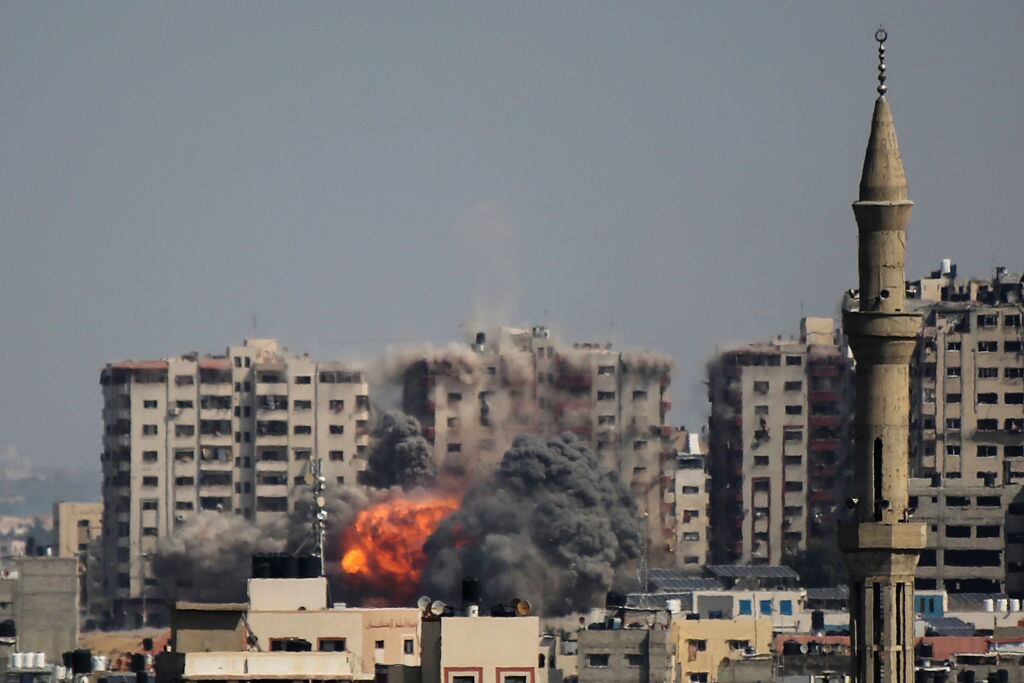 GAZA CITY, GAZA - OCTOBER 12:  An explosion on a residential tower caused by Israeli raids in the northern Gaza Strip on October 12, 2023 in Gaza City, Gaza. At least 1,200 people, including at least 326 children, have been killed and more than 300,000 displaced, after Israel launched sustained retaliatory air strikes after a large-scale attack by Hamas. On October 7, the Palestinian militant group Hamas launched a surprise attack on Israel from Gaza by land, sea, and air, killing 1000 people and wounding more than 2000. Israeli soldiers and civilians have also been taken hostage by Hamas and moved into Gaza. The attack prompted a declaration of war by Israeli Prime Minister Benjamin Netanyahu. (Photo by Ahmad Hasaballah/Getty Images)