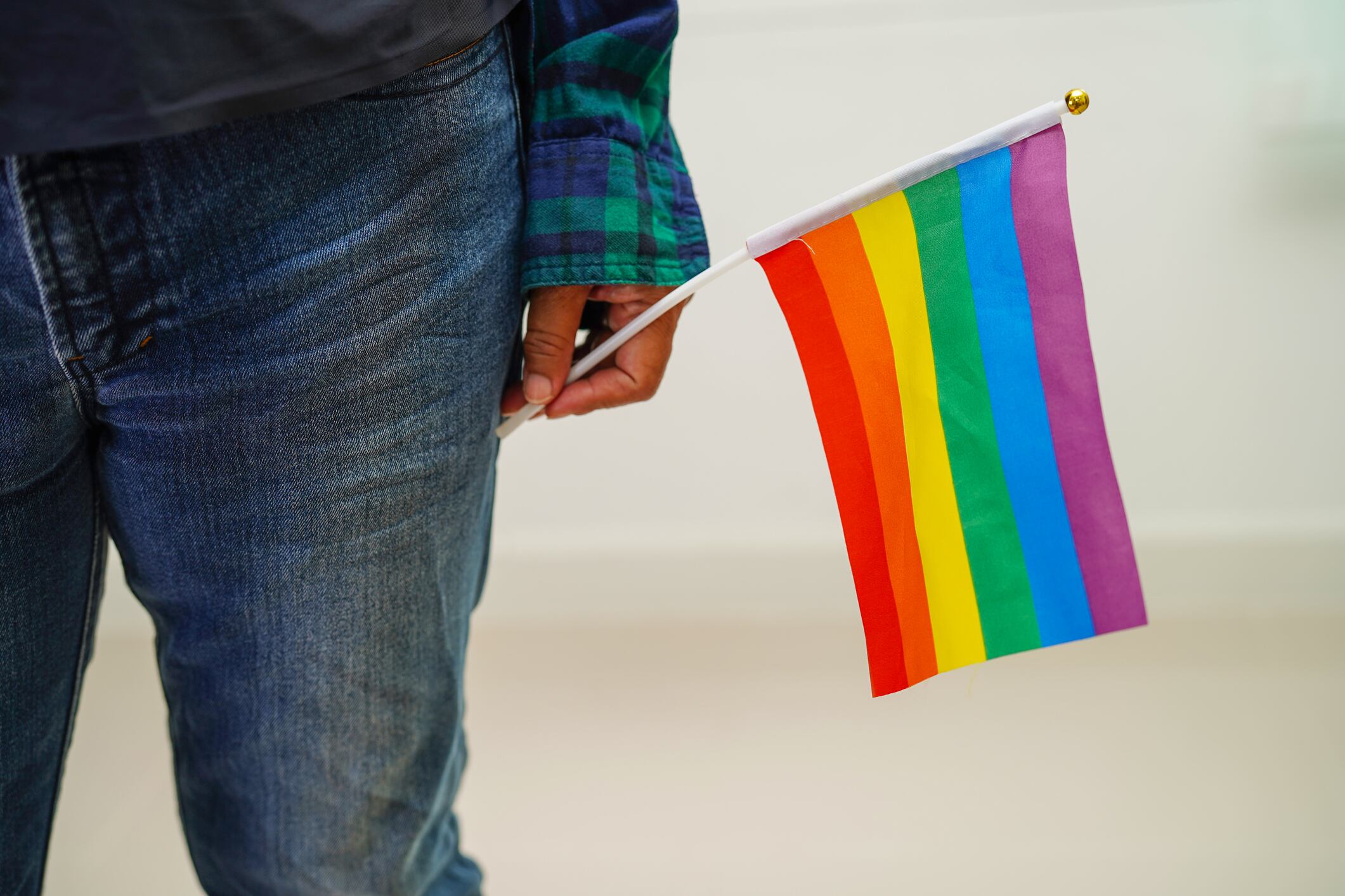 Asian woman with rainbow flag, LGBT symbol rights and gender equality, LGBT Pride Month in June, LGBTQ, LGBTI, LGBTQA, LGBTQIA