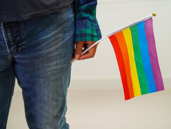Asian woman with rainbow flag, LGBT symbol rights and gender equality, LGBT Pride Month in June, LGBTQ, LGBTI, LGBTQA, LGBTQIA