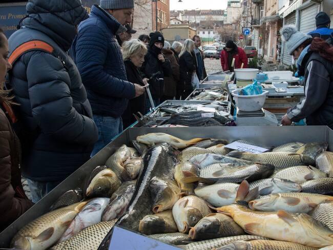 Customers in a market in Sofia buy fish on the occasion of the day of St. Nicholas, who is revered as the patron saint of sailors, travelers, merchants, and bankers. The traditional dish today is fish.