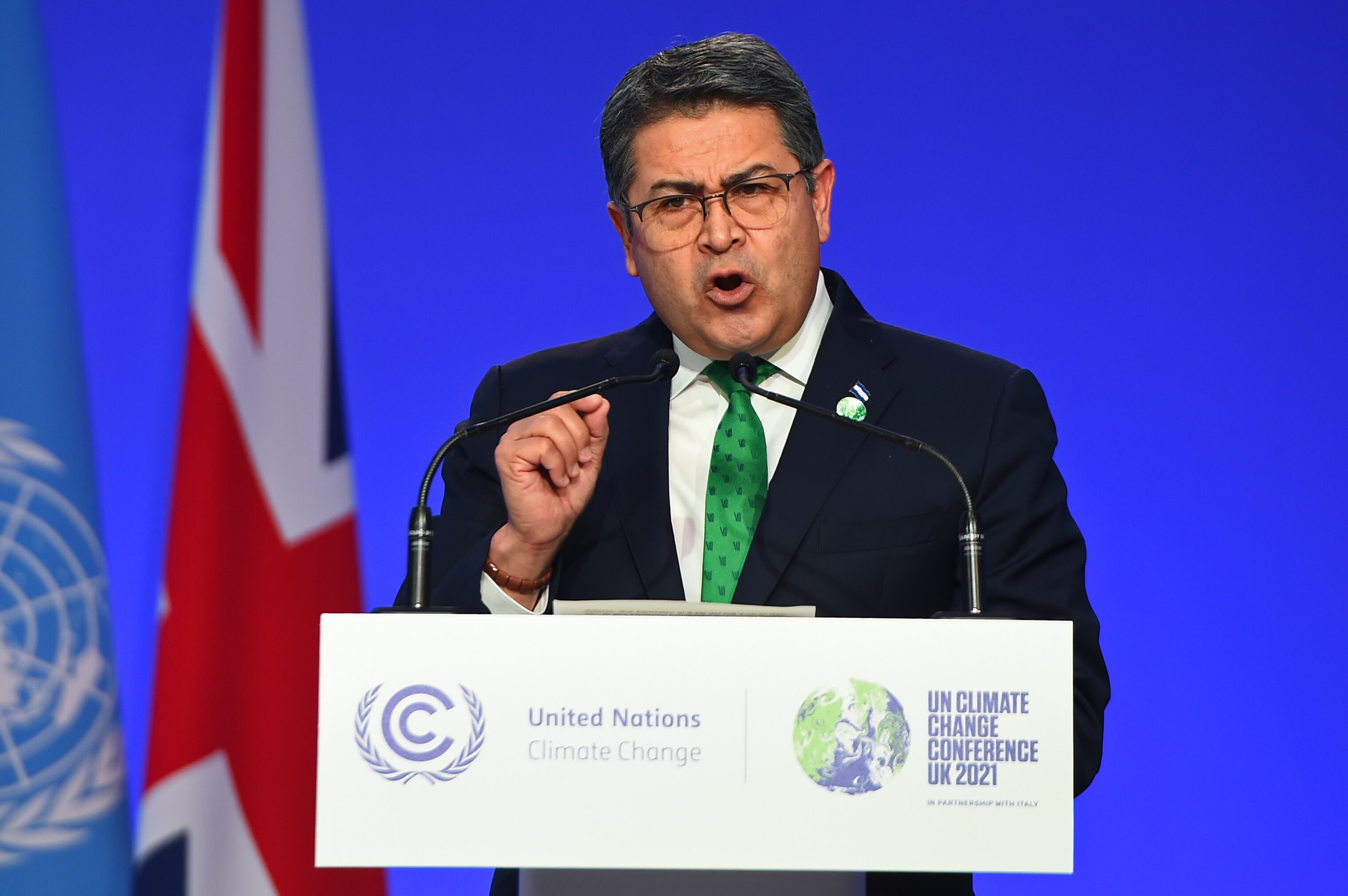 GLASGOW, SCOTLAND - NOVEMBER 01: Honduras President Juan Orlando Hernández presents his national statement during day two of COP26 at SECC on November 1, 2021 in Glasgow, United Kingdom. 2021 sees the 26th United Nations Climate Change Conference. The conference will run from 31 October for two weeks, finishing on 12 November. It was meant to take place in 2020 but was delayed due to the Covid-19 pandemic. (Photo by Andy Buchanan - Pool/Getty Images)