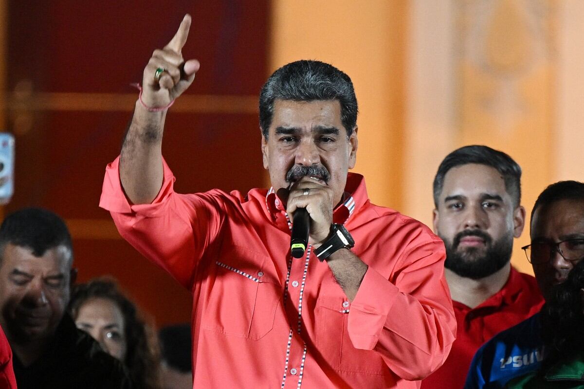 Venezuelan President Nicolas Maduro speaks to supporters as he celebrates the results of the parliamentary and regional elections at the Bolivar square in Caracas on May 25, 2025. Low turnout predominated Sunday in Venezuela's gubernatorial and parliamentary elections after the opposition majority called for abstention in protest of President Nicolas Maduro's disputed re-election. (Photo by Federico PARRA / AFP)