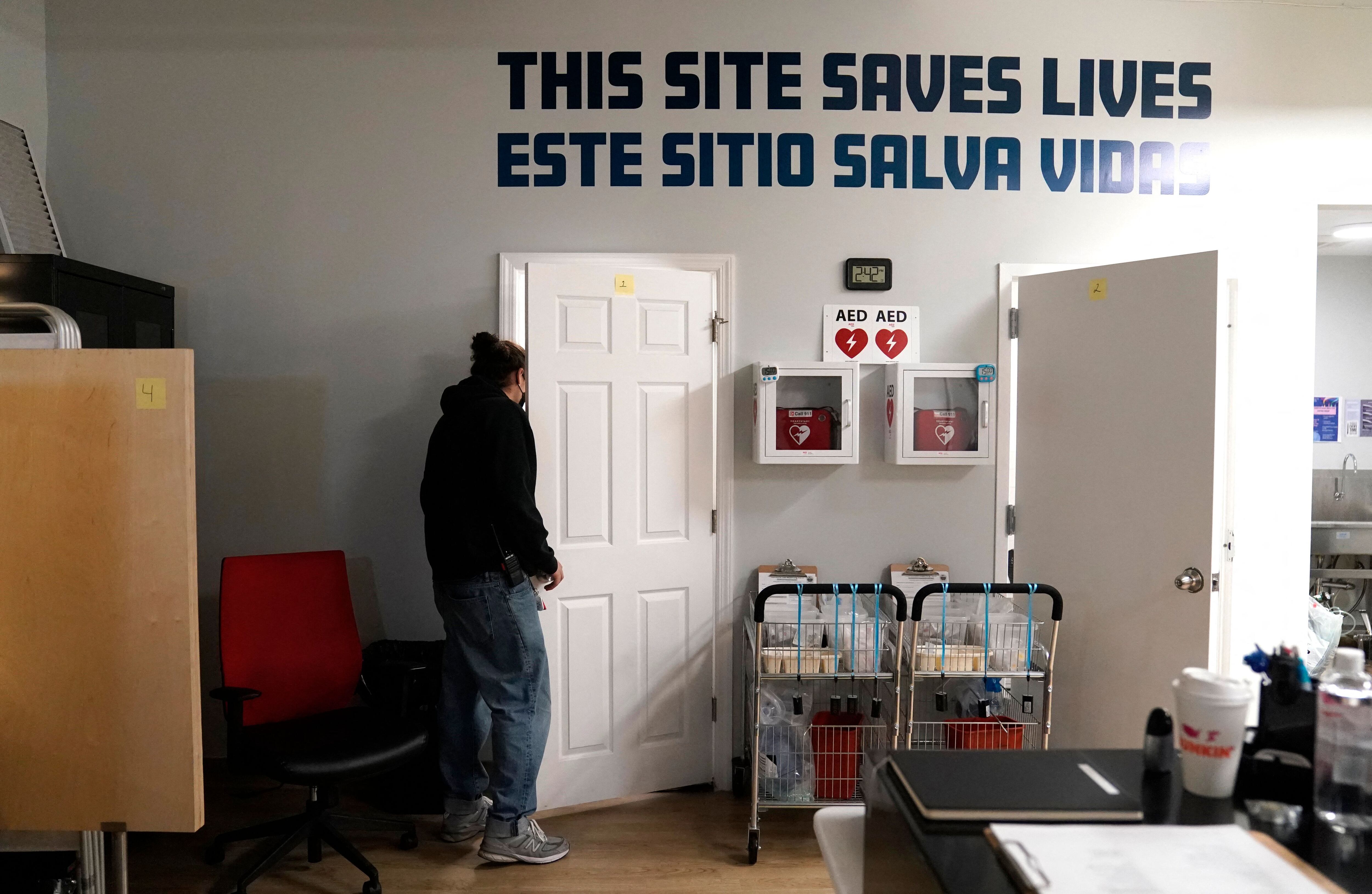 A worker checks on a patient at OnPoint NYC, the newly formed nonprofit that operates a overdose prevention center in the Harlem borough of New York on February 8, 2022. (Photo by TIMOTHY A. CLARY / AFP) (Photo by TIMOTHY A. CLARY/AFP via Getty Images)