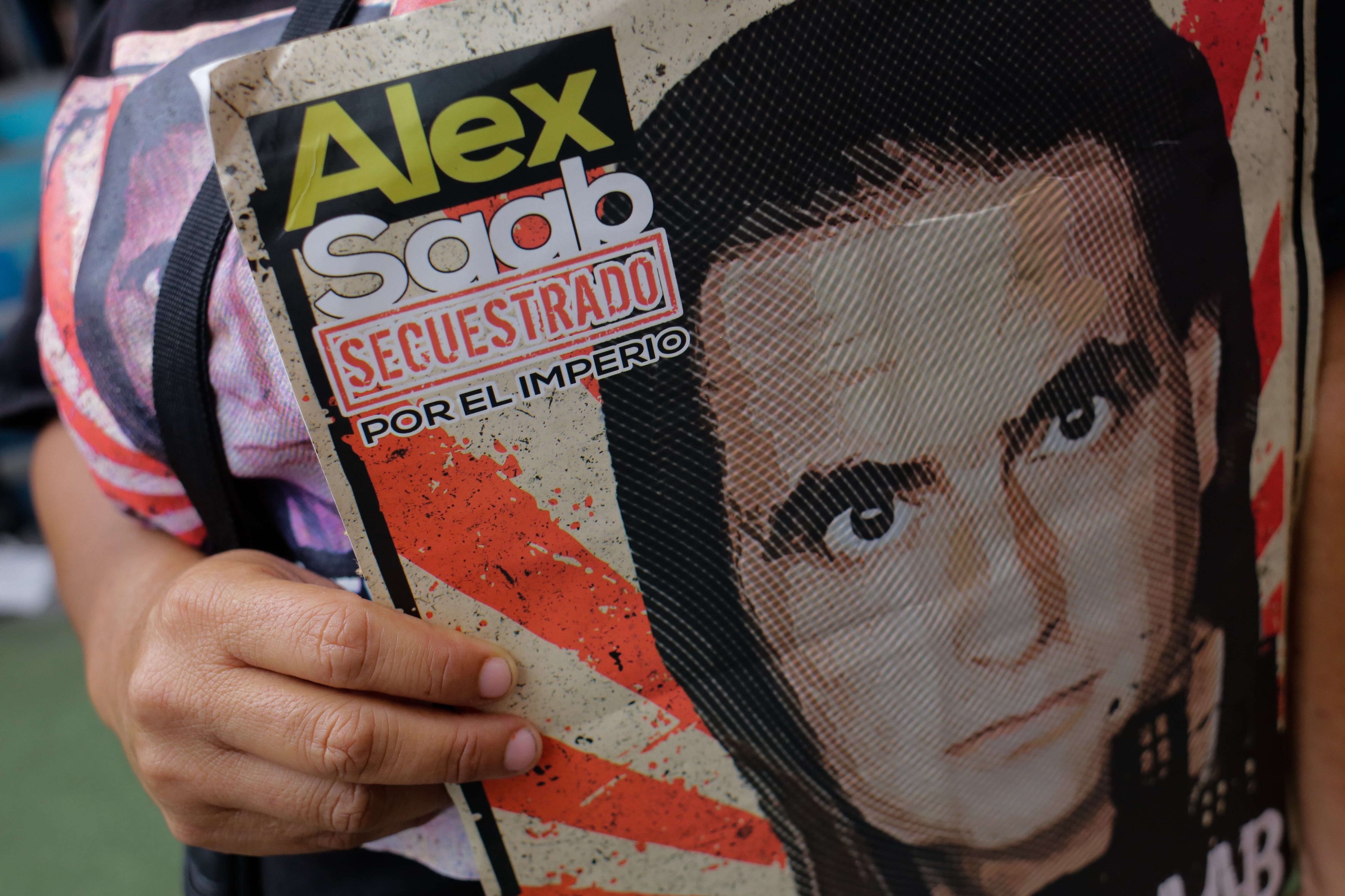 A woman holds a sign calling for the release of Alex Saab during a rally in support of the Colombian businessman who is being held in the United States, in the Petare neighborhood of Miranda Venezuela April 04, 2022  (Photo by Javier Campos/NurPhoto via Getty Images)