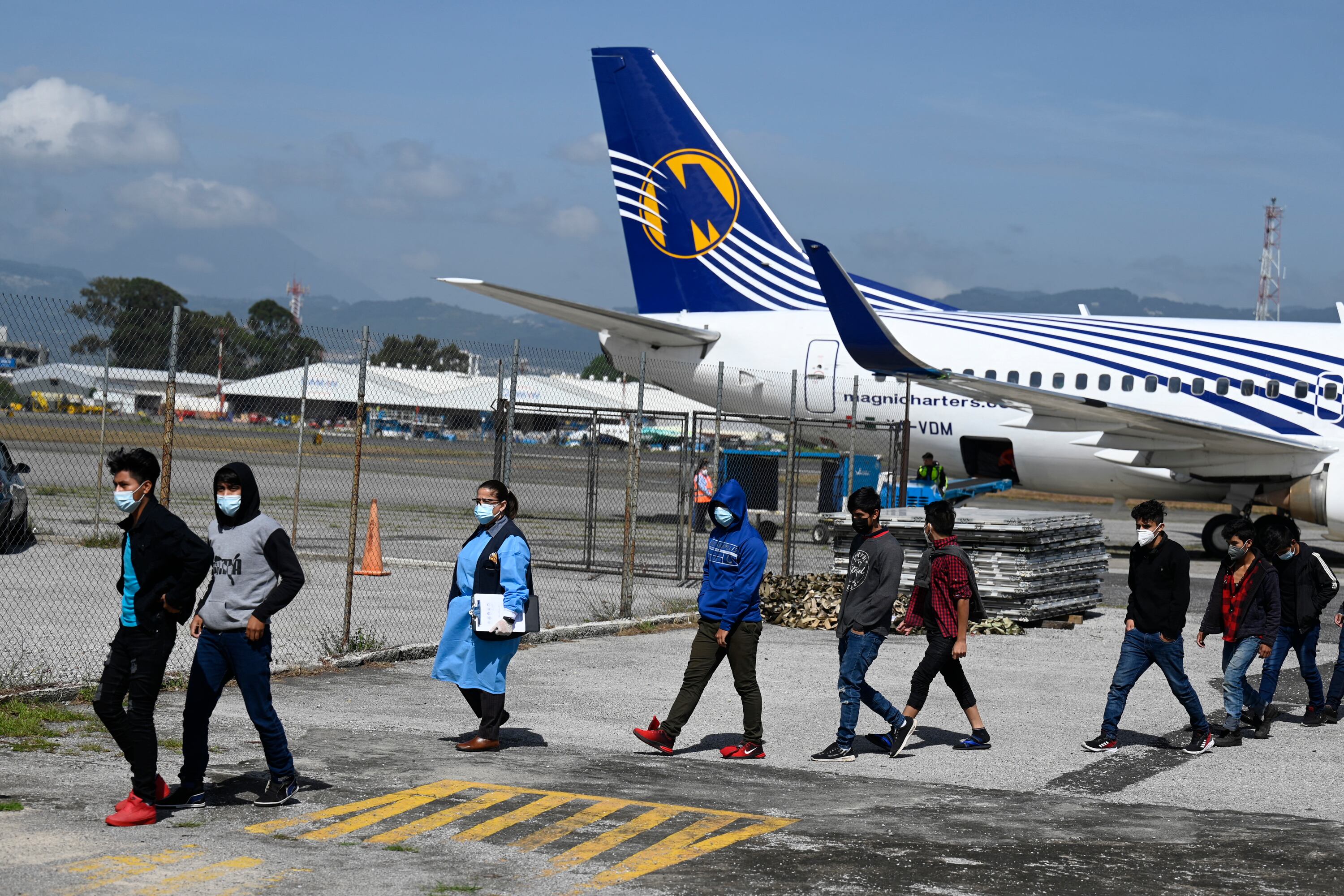 Part of a group of 136 Guatemalans deported from San Luis Potosi state, Mexico walk upon their arrival at the Air Force Base in Guatemala City on August 26, 2021. - Mexican migration authorities deported 136 Guatemalan migrants, including 61 unaccompanied minors on Thursday, according to a report by the Guatemalan Migration Institute. (Photo by Johan ORDONEZ / AFP) (Photo by JOHAN ORDONEZ/AFP via Getty Images)