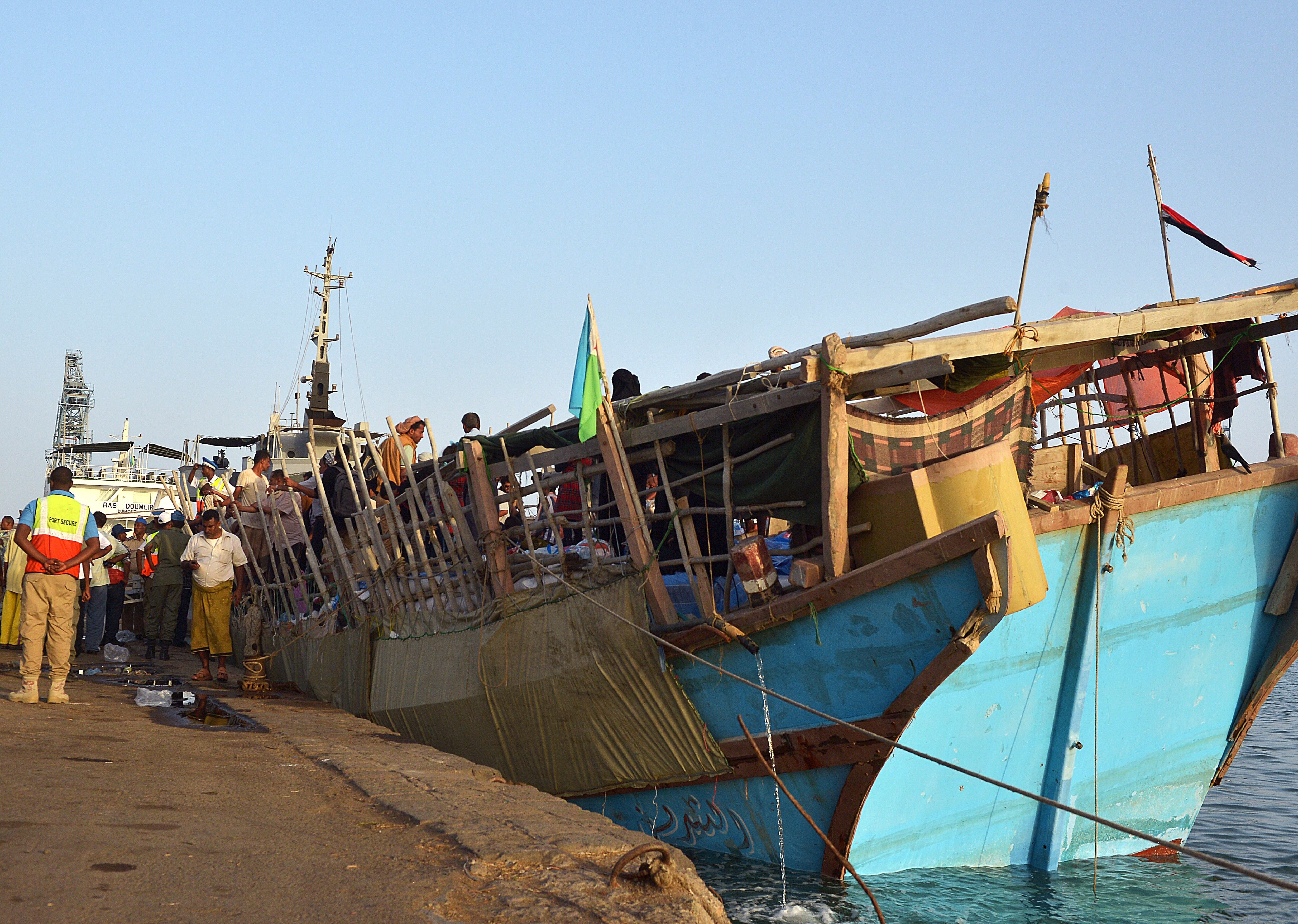 Refugees arrive aboard a boat at the port of Djibouti after crossing the Gulf of Aden to flee Yemen on April 14, 2015. Refugees from war-torn Yemen described the terror of intense airstrikes, the horror of the airstrikes that pounded their homes in Yemen, as they arrive in the Horn of Africa, where aid agencies are fearing an influx of people.  AFP PHOTO / TONY KARUMBA        (Photo credit should read TONY KARUMBA/AFP via Getty Images)