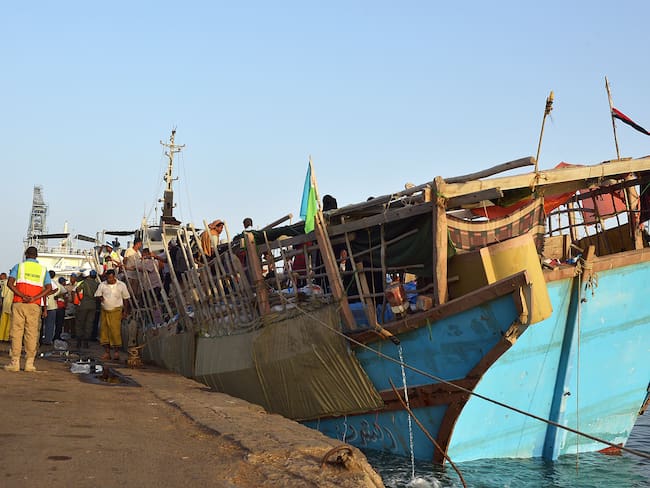 Refugees arrive aboard a boat at the port of Djibouti after crossing the Gulf of Aden to flee Yemen on April 14, 2015. Refugees from war-torn Yemen described the terror of intense airstrikes, the horror of the airstrikes that pounded their homes in Yemen, as they arrive in the Horn of Africa, where aid agencies are fearing an influx of people.  AFP PHOTO / TONY KARUMBA        (Photo credit should read TONY KARUMBA/AFP via Getty Images)