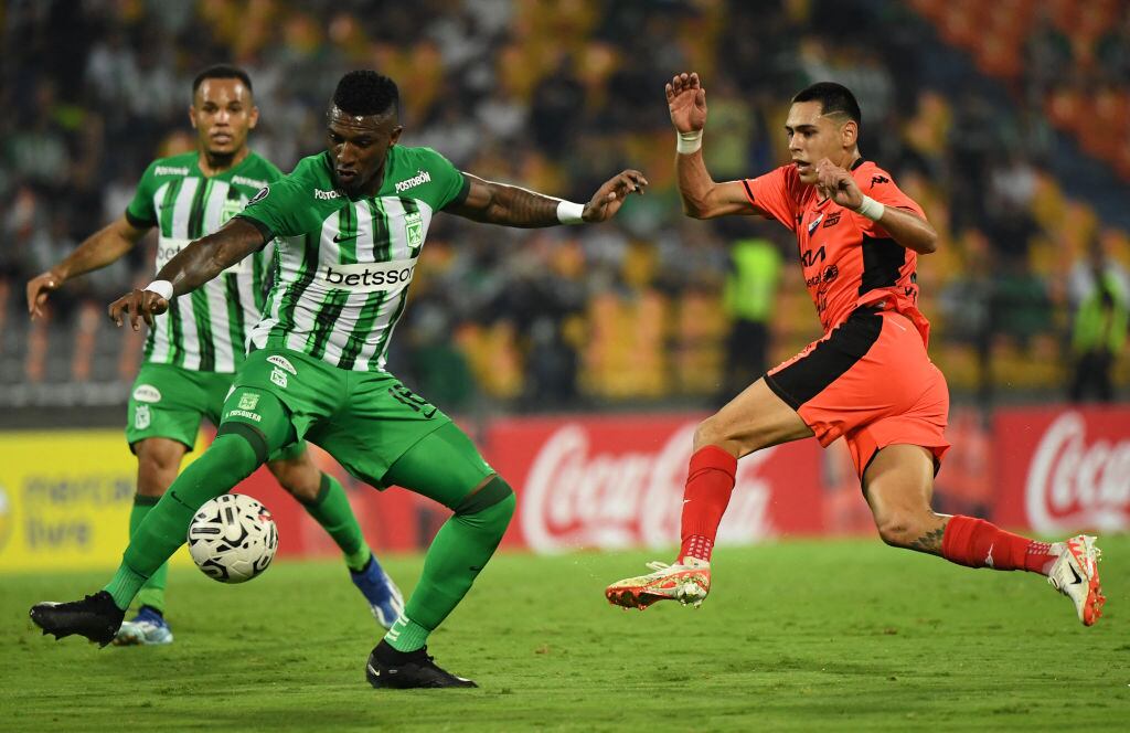 Atletico Nacional's defender Edier Ocampo (L) and Nacional's forward Gustavo Caballero fight for the ball during the Copa Libertadores' second round second leg football match between Colombia's Atletico Nacional and Paraguay's Nacional at the Atanasio Girardot  stadium in Medellin on February 28, 2024. (Photo by Jaime SALDARRIAGA / AFP) (Photo by JAIME SALDARRIAGA/AFP via Getty Images)