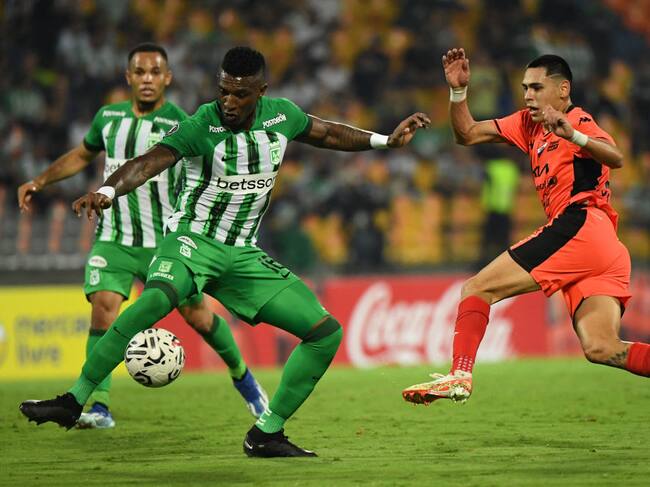 Atletico Nacional's defender Edier Ocampo (L) and Nacional's forward Gustavo Caballero fight for the ball during the Copa Libertadores' second round second leg football match between Colombia's Atletico Nacional and Paraguay's Nacional at the Atanasio Girardot stadium in Medellin on February 28, 2024. (Photo by Jaime SALDARRIAGA / AFP) (Photo by JAIME SALDARRIAGA/AFP via Getty Images)