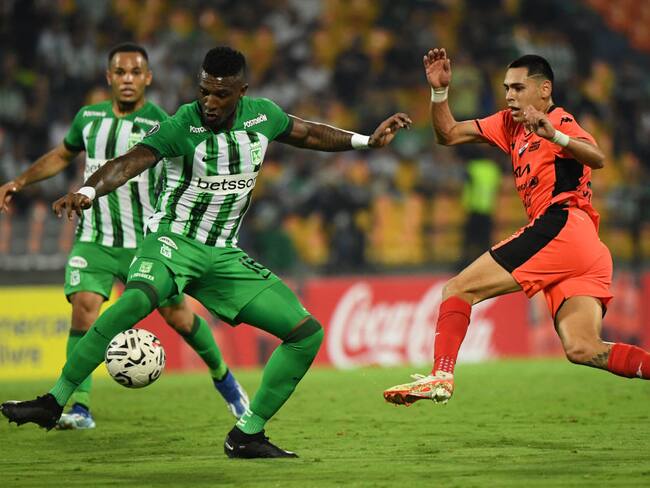 Atletico Nacional's defender Edier Ocampo (L) and Nacional's forward Gustavo Caballero fight for the ball during the Copa Libertadores' second round second leg football match between Colombia's Atletico Nacional and Paraguay's Nacional at the Atanasio Girardot stadium in Medellin on February 28, 2024. (Photo by Jaime SALDARRIAGA / AFP) (Photo by JAIME SALDARRIAGA/AFP via Getty Images)
