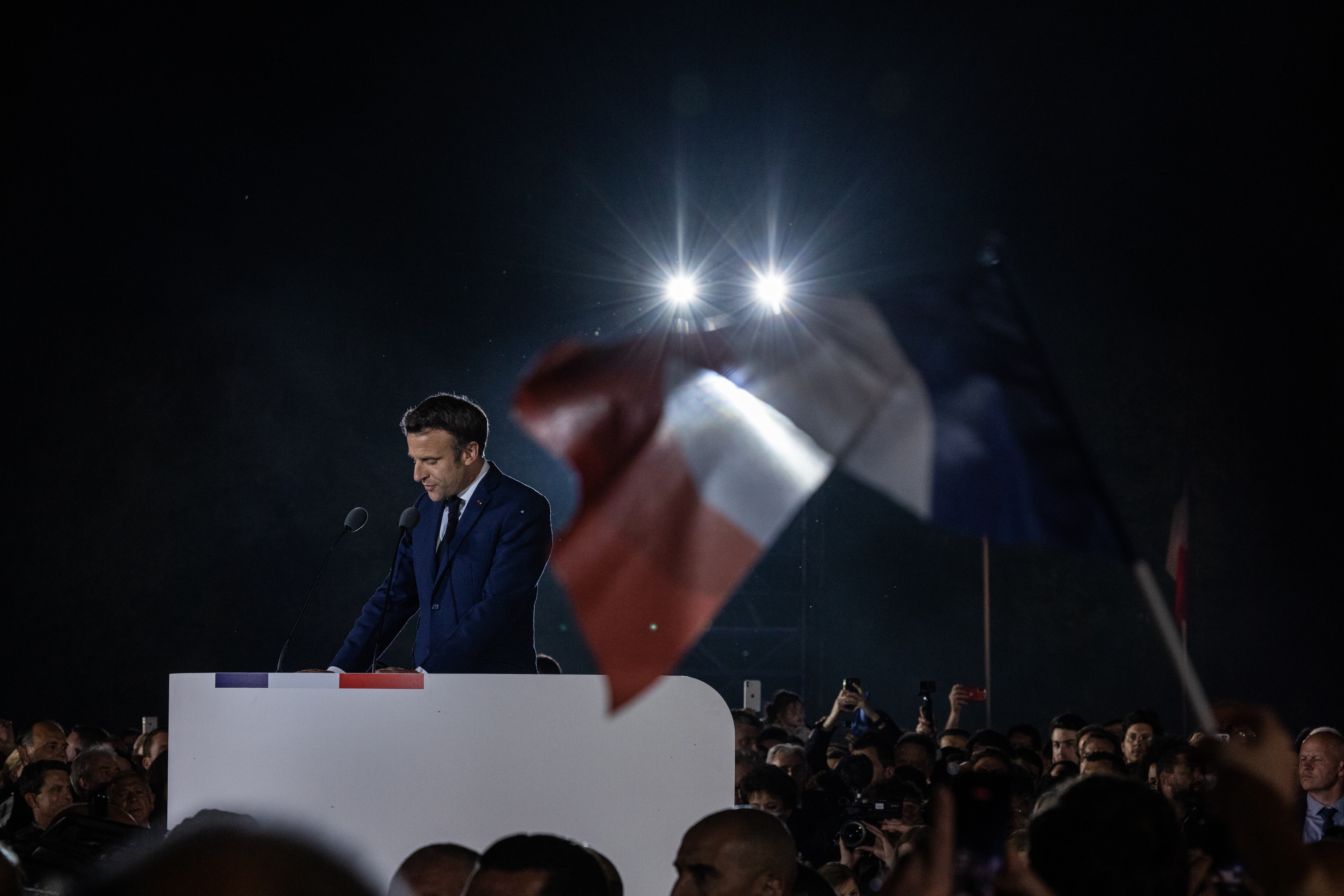 PARIS, FRANCE - APRIL 24: Emmanuel Macron addresses supporters after defeating Marine Le Pen for a second five-year term as president in the French presidential election on April 24, 2022 in Paris, France. Emmanuel Macron and Marine Le Pen both qualified on Sunday April 10th for France's 2022 presidential election second round held today, on April 24. This is the second consecutive time the two candidates face-off in the final round of elections. (Photo by Louise Delmotte/Getty Images)