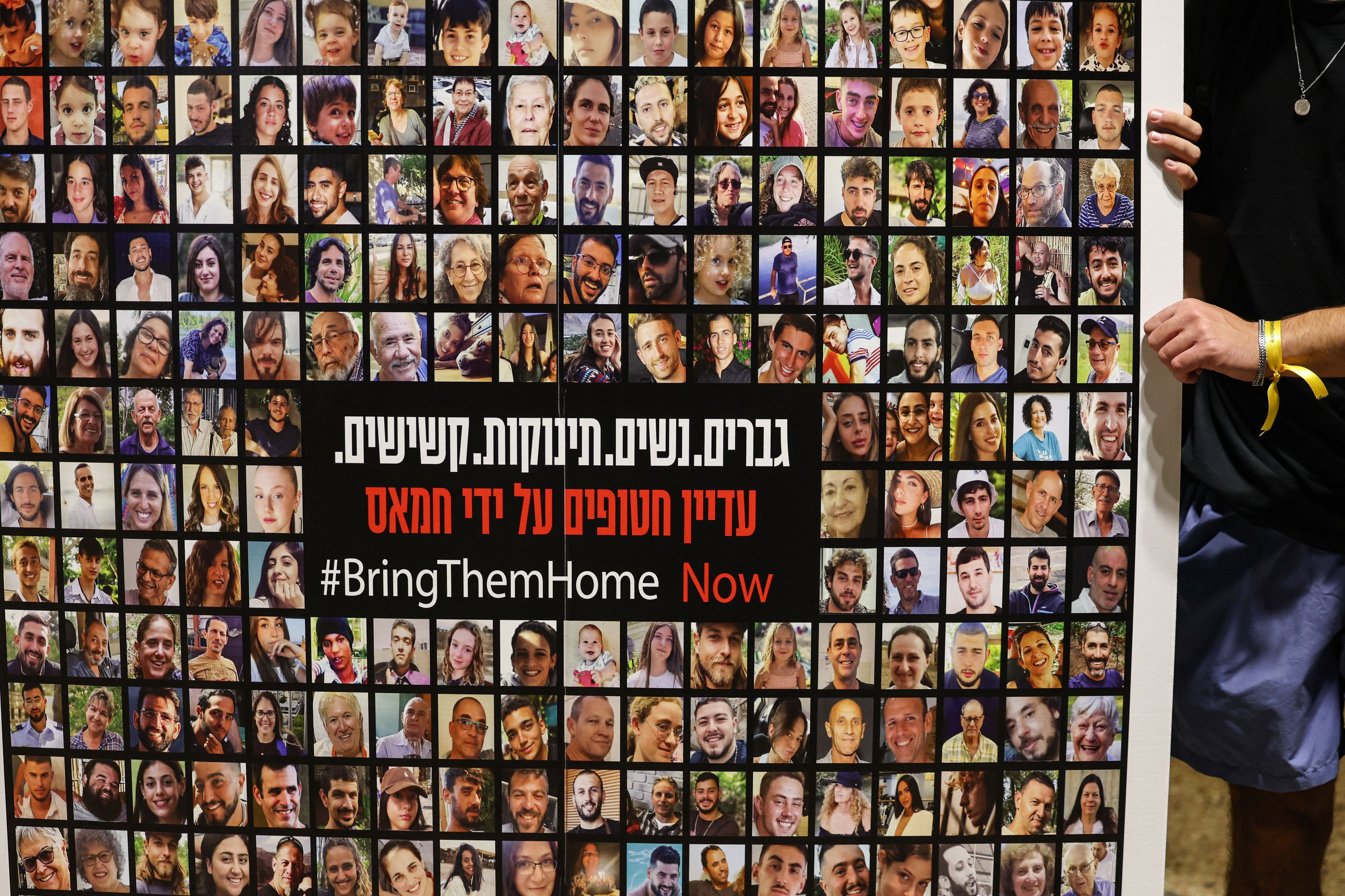 Relatives, friends and supporters of Israeli hostages held in Gaza since the October 7 attack by Hamas militants in southern Israel, hold placards and images of those taken during a protest for their release in Tel Aviv on November 22, 2023. (Photo by AHMAD GHARABLI / AFP) (Photo by AHMAD GHARABLI/AFP via Getty Images)