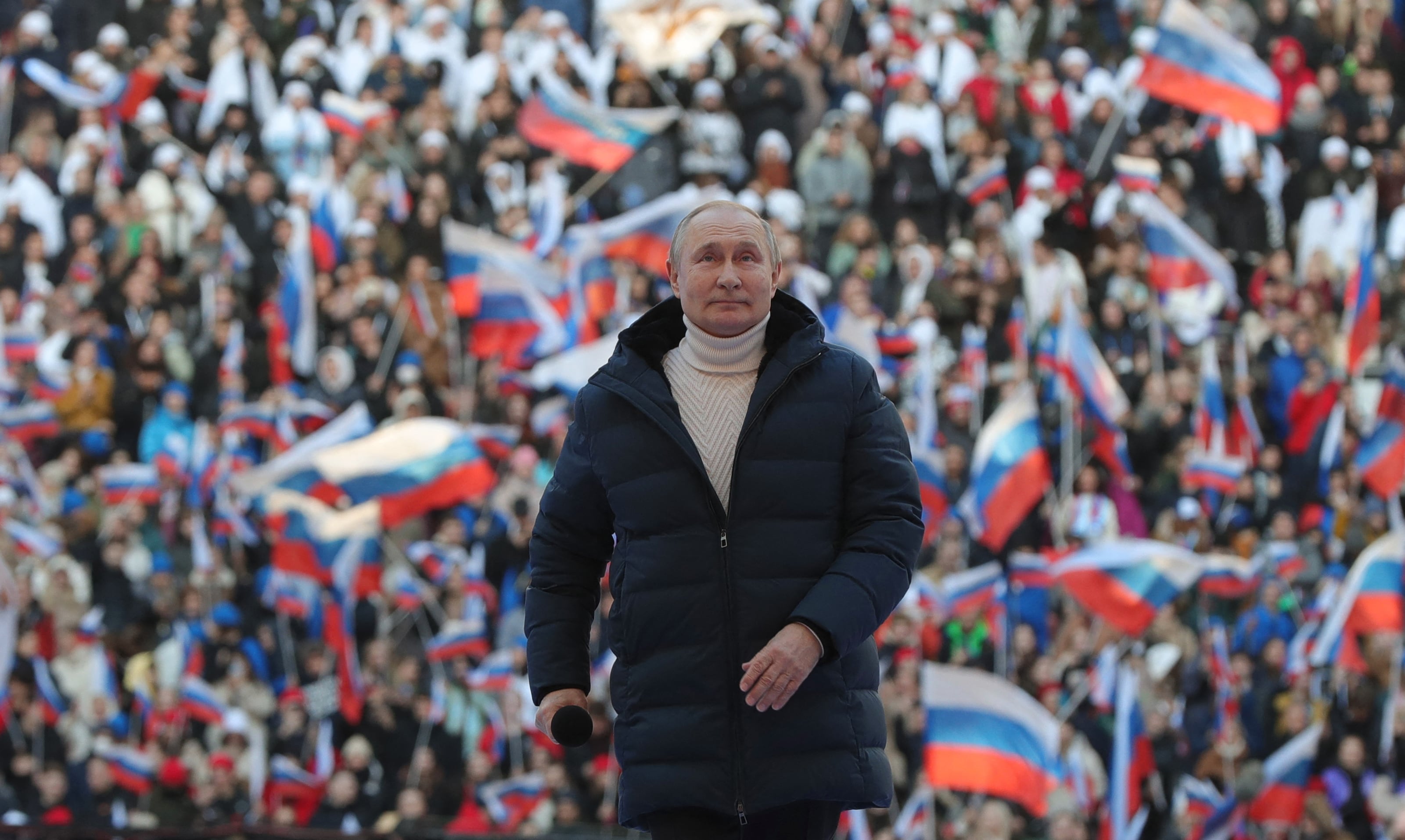 TOPSHOT - Russian President Vladimir Putin attends a concert marking the eighth anniversary of Russia's annexation of Crimea at the Luzhniki stadium in Moscow on March 18, 2022. (Photo by Mikhail KLIMENTYEV / SPUTNIK / AFP) (Photo by MIKHAIL KLIMENTYEV/SPUTNIK/AFP via Getty Images)
