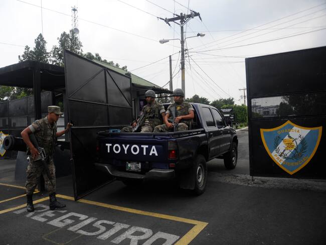Guatemalan soldiers arrive at the Matamoros military prison where former Guatemalan de facto President (1982-1983), retired General Jose Efrain Rios Montt is serving sentence, in Guatemala city on May 12, 2013. Rios Montt was found guilty of genocide and war crimes on May 10 and sentenced to 80 years in prison in a landmark ruling stemming from massacres of indigenous people in his country's long civil war. Rios Montt thus became the first Latin American convicted of trying to exterminate an entire group of people in a brief but particularly gruesome stretch of a war that started in 1960, lasted 36 years and left around 200,000 people dead or missing. AFP PHOTO / Johan ORDONEZ (Photo credit should read JOHAN ORDONEZ/AFP via Getty Images)