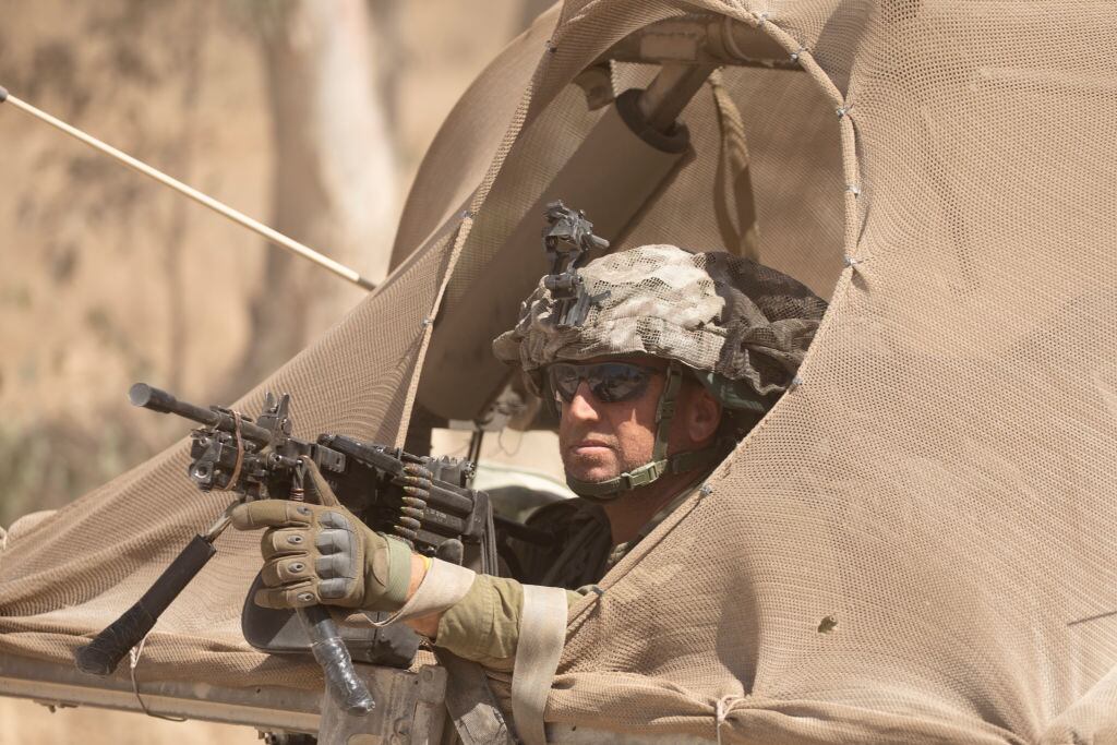 An Israeli soldier guards in an army vehicle as it is moving along the border with the Gaza Strip on June 10, 2024 in Southern Israel, Israel.(Photo by Amir Levy/Getty Images)