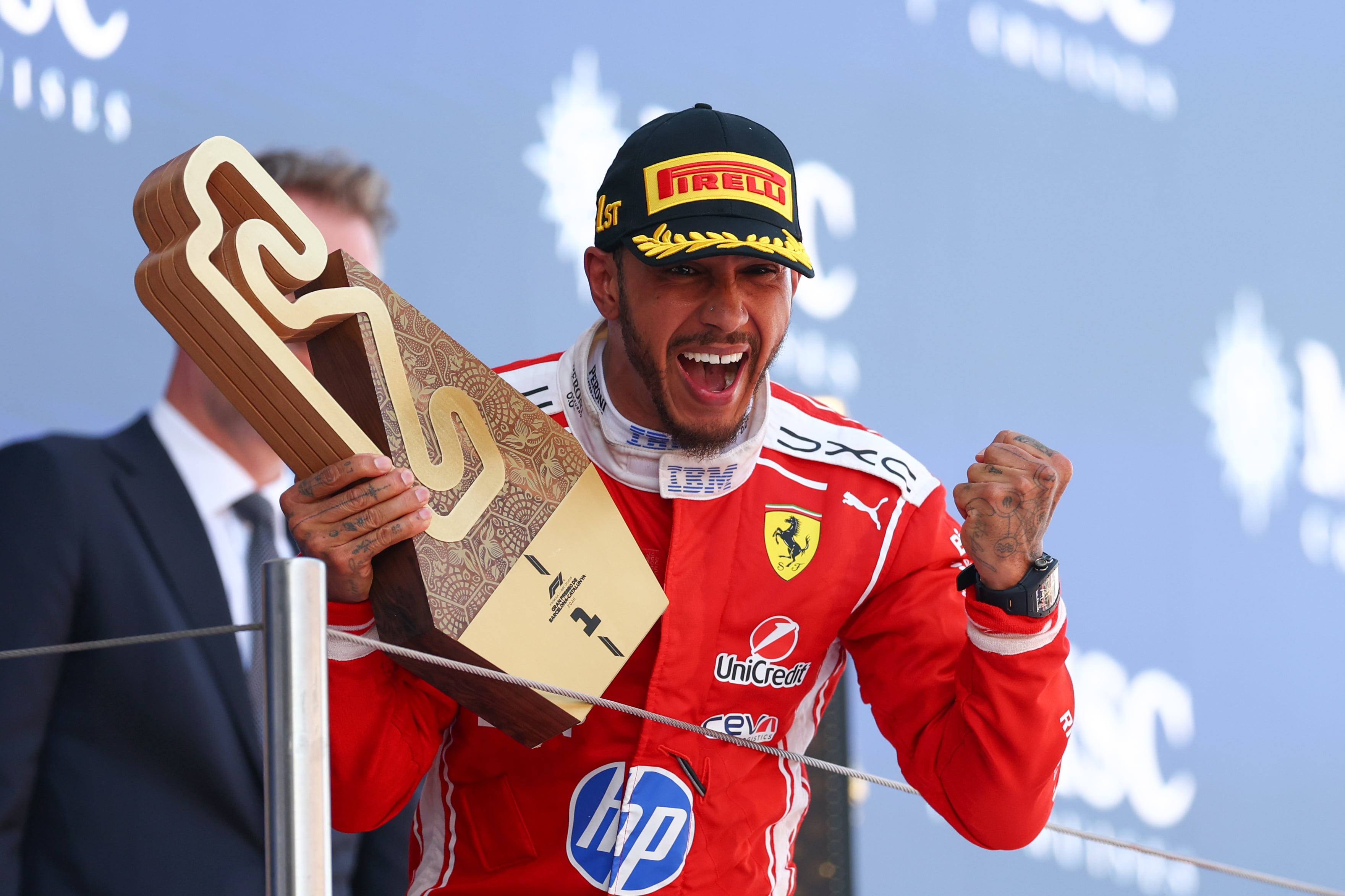 BARCELONA, SPAIN - JUNE 14: Race winner Lewis Hamilton of Great Britain and Scuderia Ferrari celebrates on the podium with his trophy during the F1 Grand Prix of Barcelona-Catalunya at Circuit de Barcelona-Catalunya on June 14, 2026 in Barcelona, Spain. (Photo by Clive Mason/Getty Images)