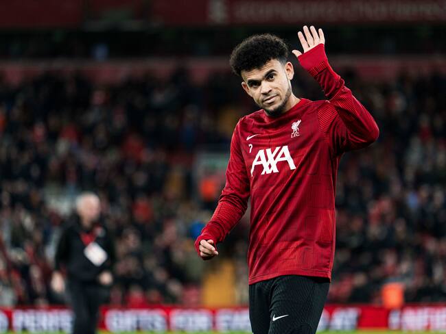 LIVERPOOL, ENGLAND - DECEMBER 20: Luis Díaz of Liverpool waves to the fans during the warm up before the Carabao Cup Quarter Final match between Liverpool and West Ham United at Anfield on December 20, 2023 in Liverpool, England. (Photo by MB Media/Getty Images)