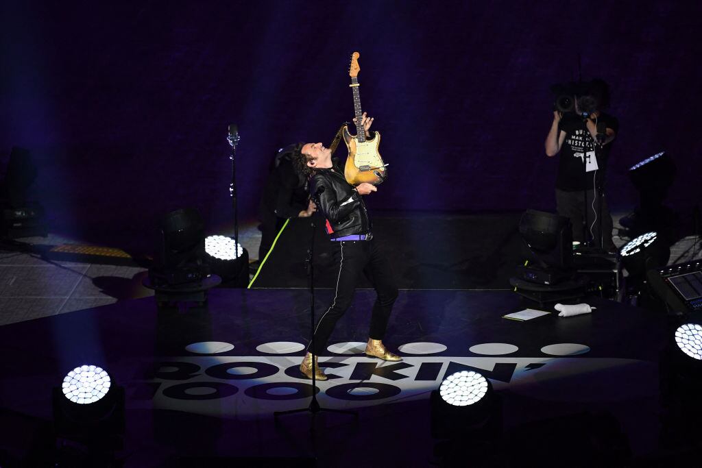 French singer Mathieu Chedid aka M performs with the musicians of the Rockin'1000 band (Photo by JULIEN DE ROSA/AFP via Getty Images)