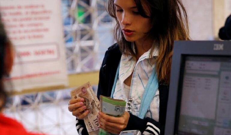 Una persona realizando compras en un supermercado en Caracas