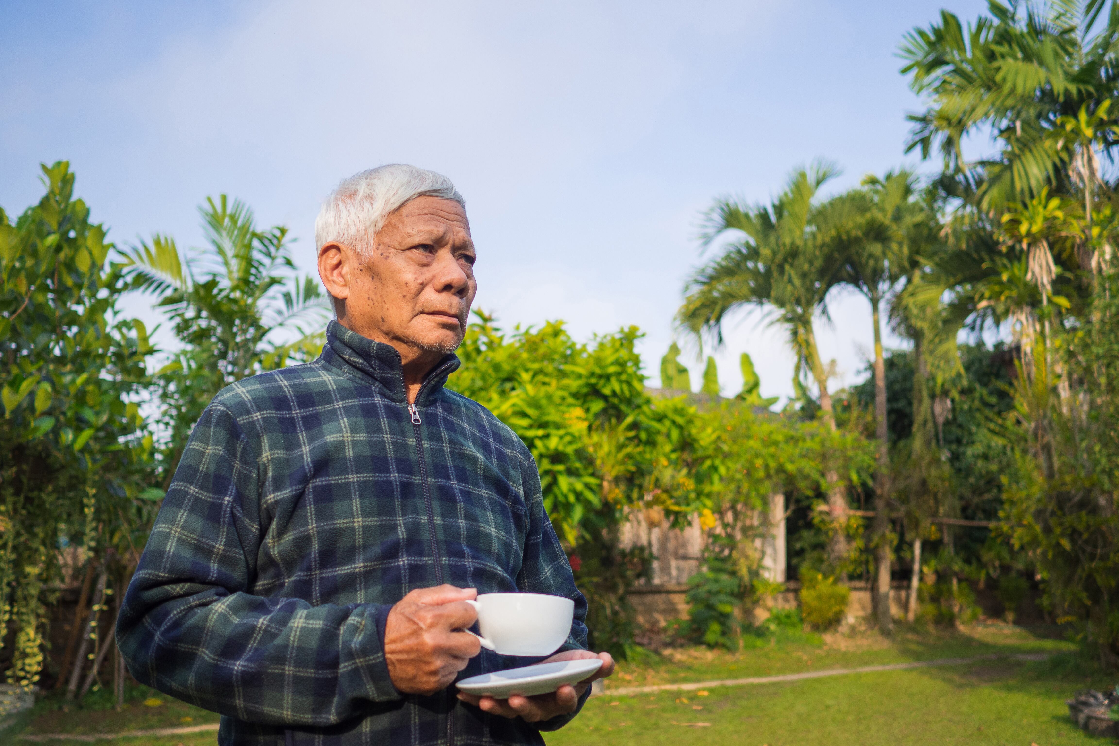 Señor tomando café y rodeado de naturaleza. (Foto: Getty Images)