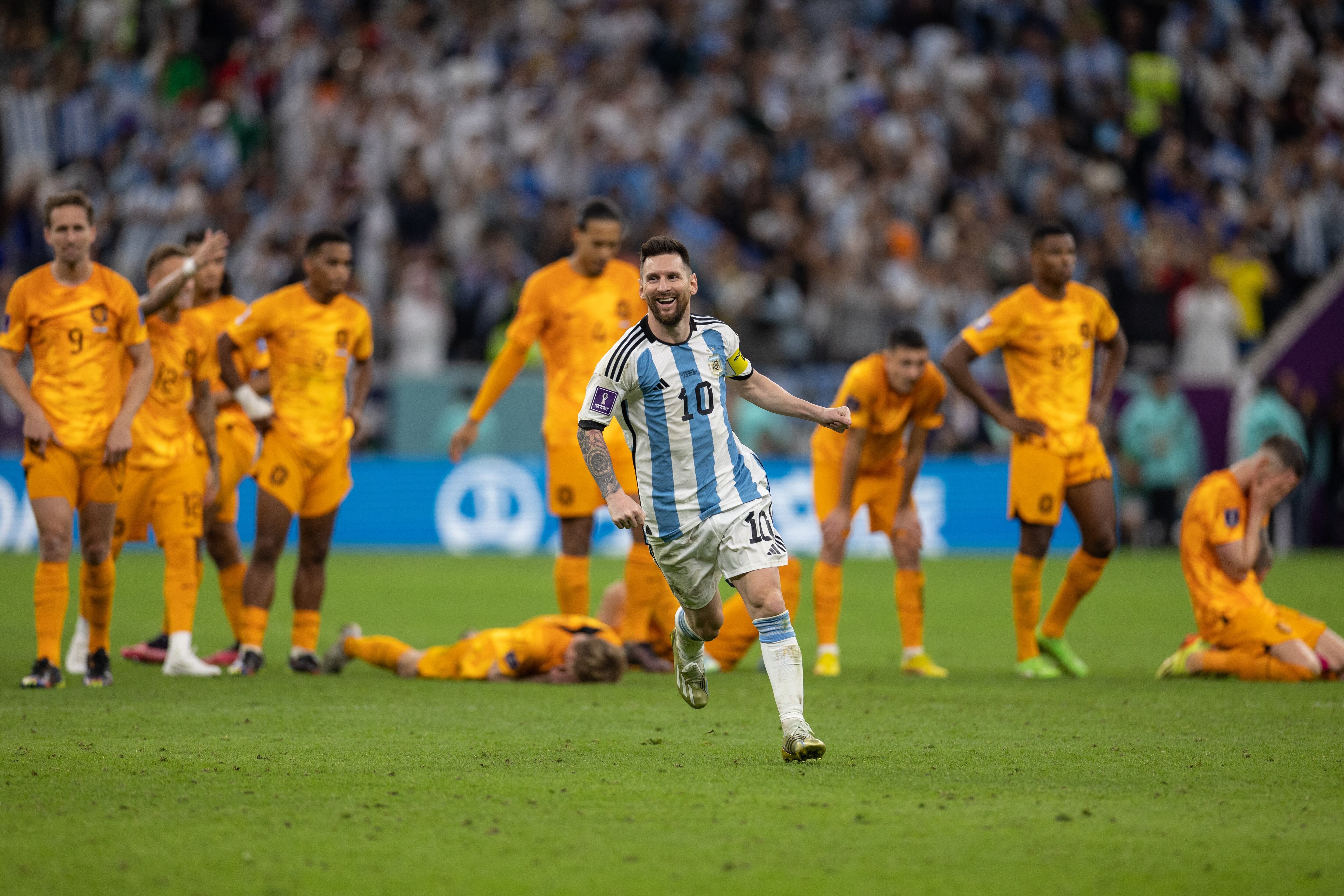 LUSAIL CITY, QATAR - DECEMBER 09:: Lionel Messi of Argentina celebrates in front of the dejected Netherlands players as Argentina win on penalties during the FIFA World Cup Qatar 2022 quarter final match between Netherlands (2) and Argentina (2) (Argentina win 4-3 on penalties) at Lusail Stadium on December 09, 2022 in Lusail City, Qatar. (Photo by Simon Bruty/Anychance/Getty Images)