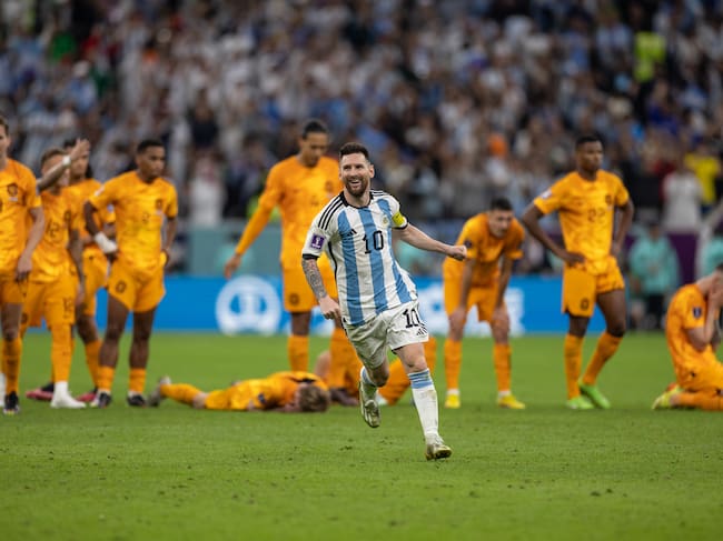 LUSAIL CITY, QATAR - DECEMBER 09:: Lionel Messi of Argentina celebrates in front of the dejected Netherlands players as Argentina win on penalties during the FIFA World Cup Qatar 2022 quarter final match between Netherlands (2) and Argentina (2) (Argentina win 4-3 on penalties) at Lusail Stadium on December 09, 2022 in Lusail City, Qatar. (Photo by Simon Bruty/Anychance/Getty Images)