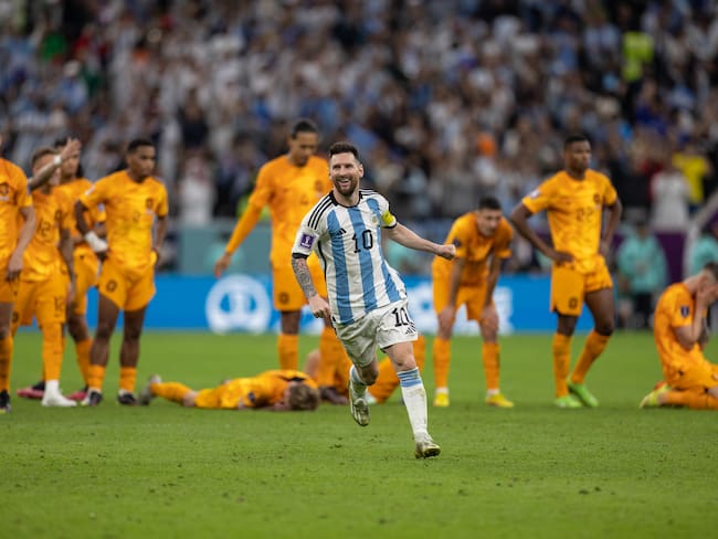 LUSAIL CITY, QATAR - DECEMBER 09:: Lionel Messi of Argentina celebrates in front of the dejected Netherlands players as Argentina win on penalties during the FIFA World Cup Qatar 2022 quarter final match between Netherlands (2) and Argentina (2) (Argentina win 4-3 on penalties) at Lusail Stadium on December 09, 2022 in Lusail City, Qatar. (Photo by Simon Bruty/Anychance/Getty Images)