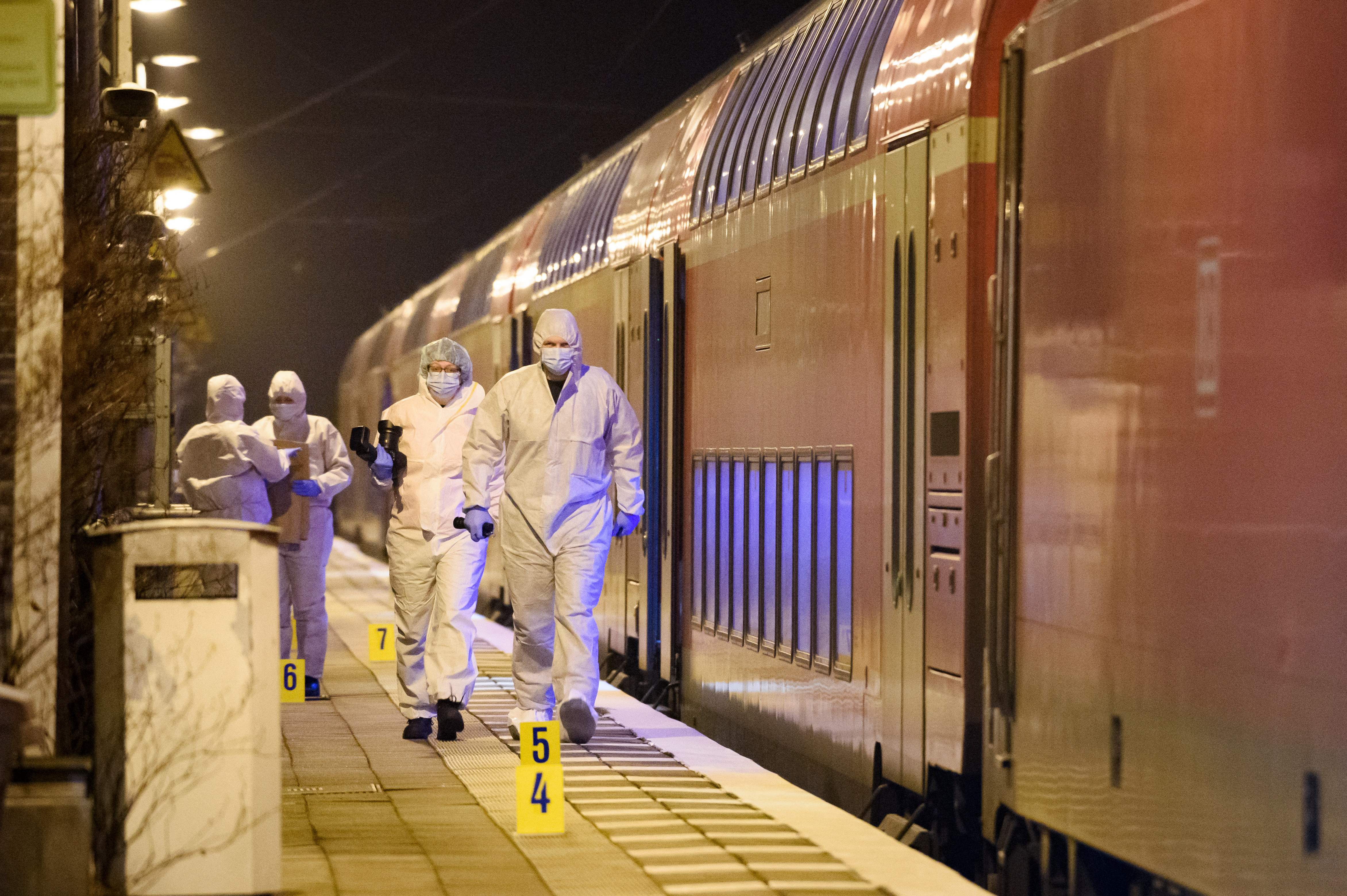 Forensic staff of the police secures and photographs evidence on the platform of the train station in Brokstedt, northern Germany, on January 25, 2023, after two people were killed and several others wounded in a knife attack on a regional train between the cities of Hamburg and Kiel. - Police announced that the alleged assailant had been captured. The suspect was taken into custody at the railway station in the town of Brokstedt. It was not immediately clear how many people had been injured or how serious their condition was. Media reports cited around five wounded. (Photo by Gregor Fischer / AFP) (Photo by GREGOR FISCHER/AFP via Getty Images)