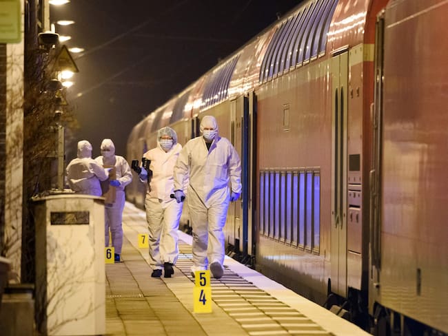 Forensic staff of the police secures and photographs evidence on the platform of the train station in Brokstedt, northern Germany, on January 25, 2023, after two people were killed and several others wounded in a knife attack on a regional train between the cities of Hamburg and Kiel. - Police announced that the alleged assailant had been captured. The suspect was taken into custody at the railway station in the town of Brokstedt. It was not immediately clear how many people had been injured or how serious their condition was. Media reports cited around five wounded. (Photo by Gregor Fischer / AFP) (Photo by GREGOR FISCHER/AFP via Getty Images)