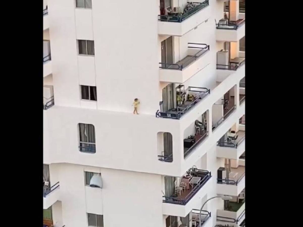 ¿Y sus padres? Niña corre y juega al borde de un edificio